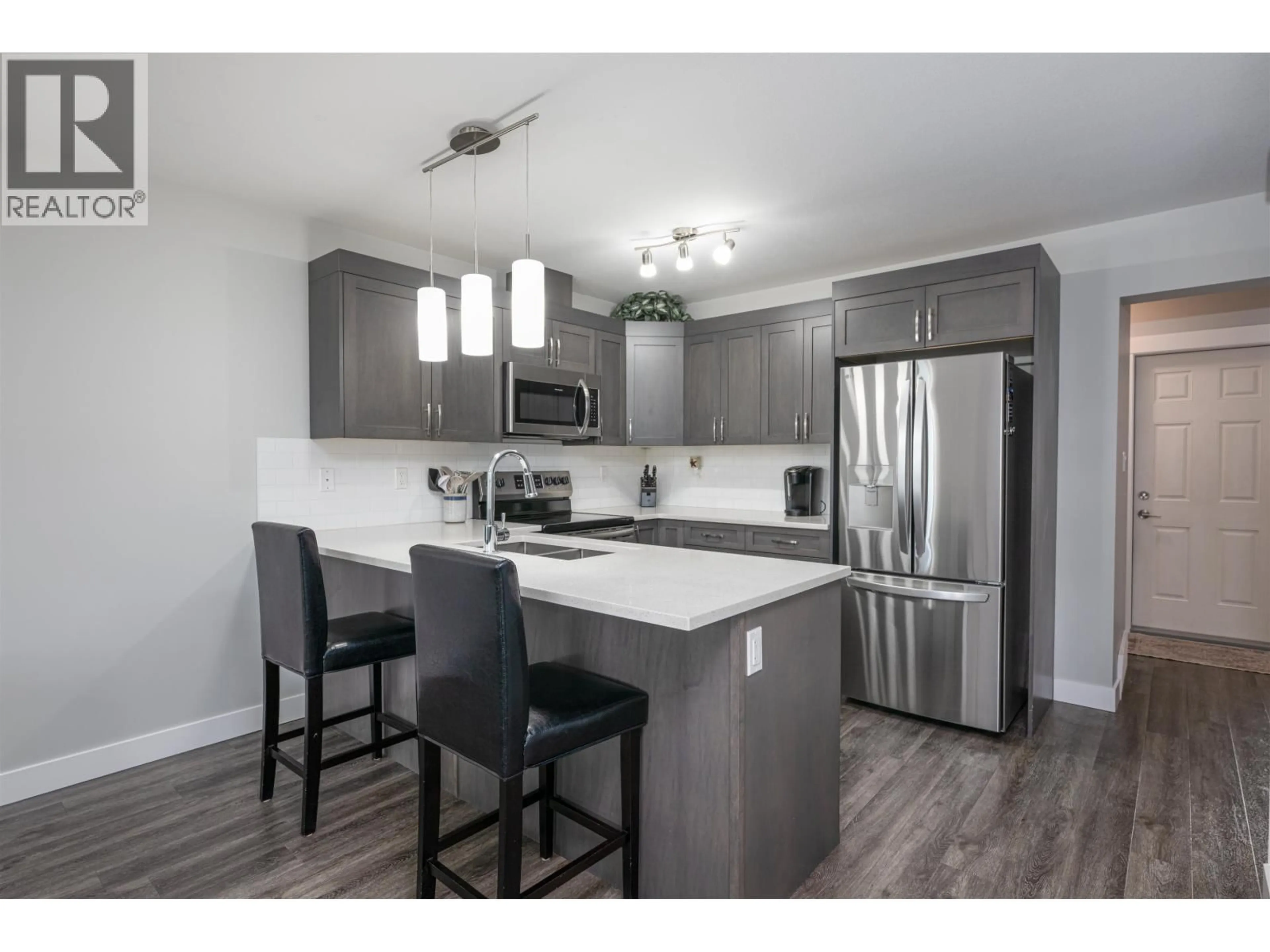 Open concept kitchen, wood/laminate floor for 303 - 6798 WESTGATE AVENUE, Prince George British Columbia V2N0H6