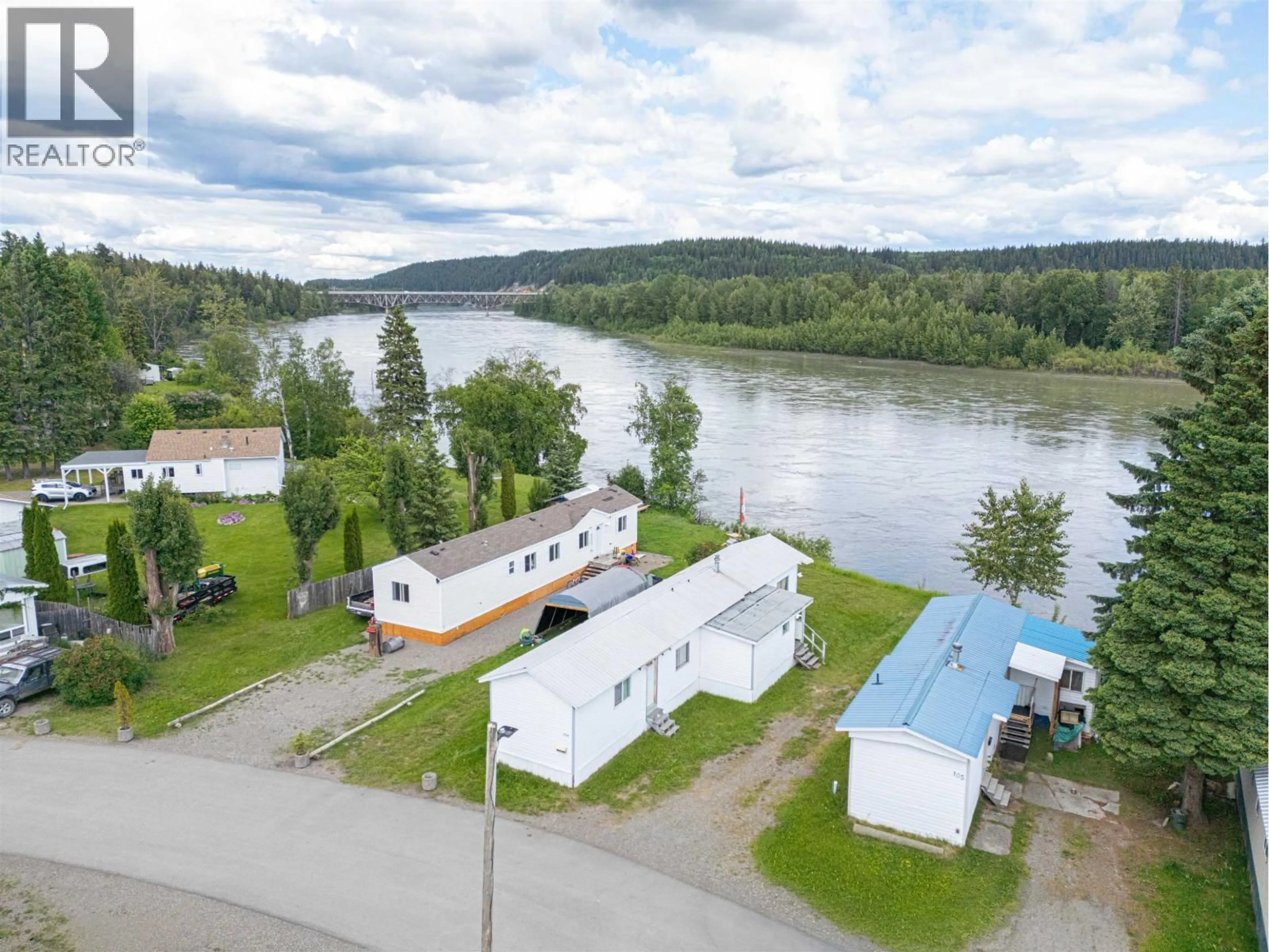 A pic from outside/outdoor area/front of a property/back of a property/a pic from drone, water/lake/river/ocean view for 104 - 3730 LANSDOWNE ROAD, Prince George British Columbia V2N2S5