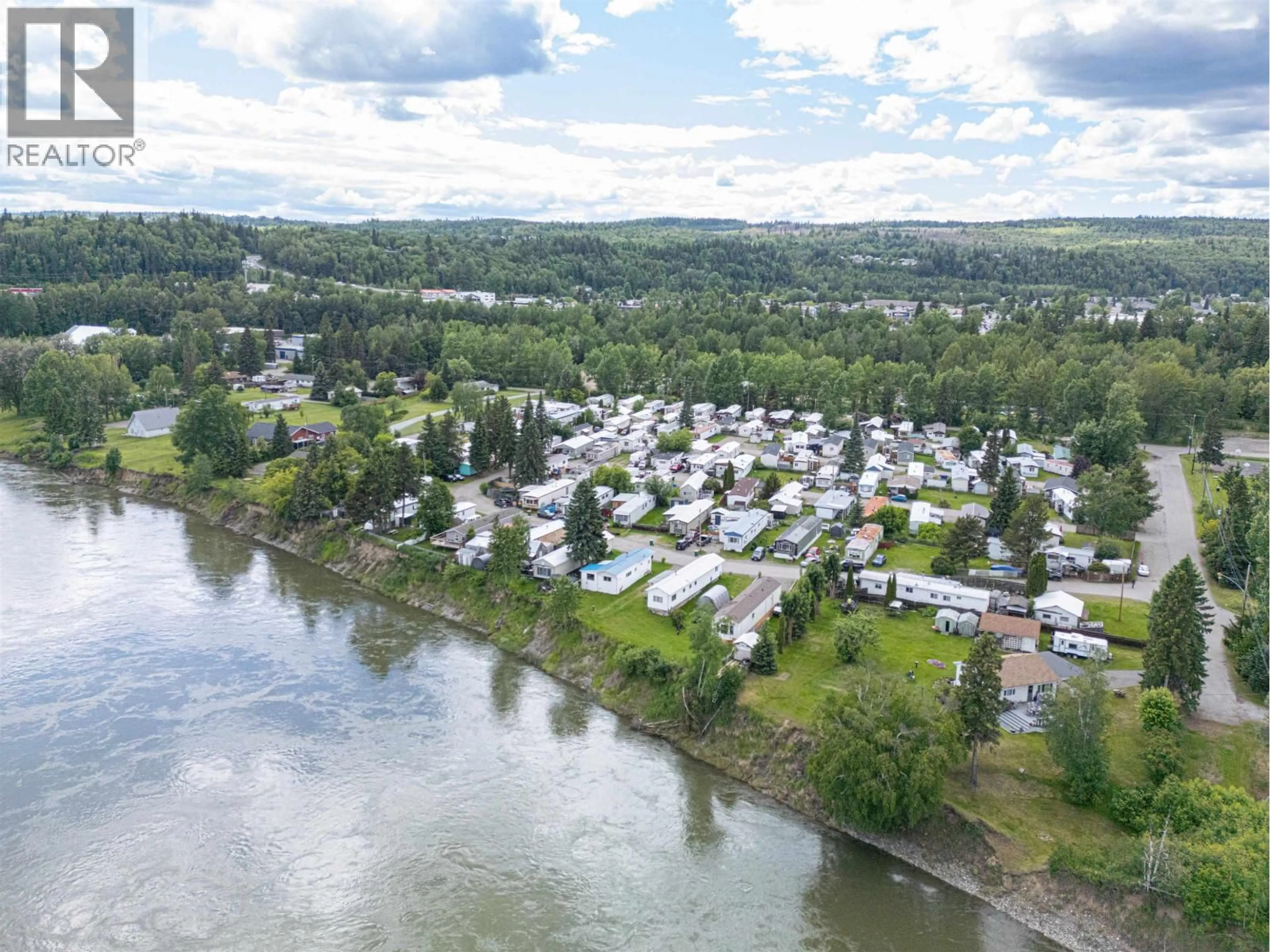 A pic from outside/outdoor area/front of a property/back of a property/a pic from drone, water/lake/river/ocean view for 104 - 3730 LANSDOWNE ROAD, Prince George British Columbia V2N2S5