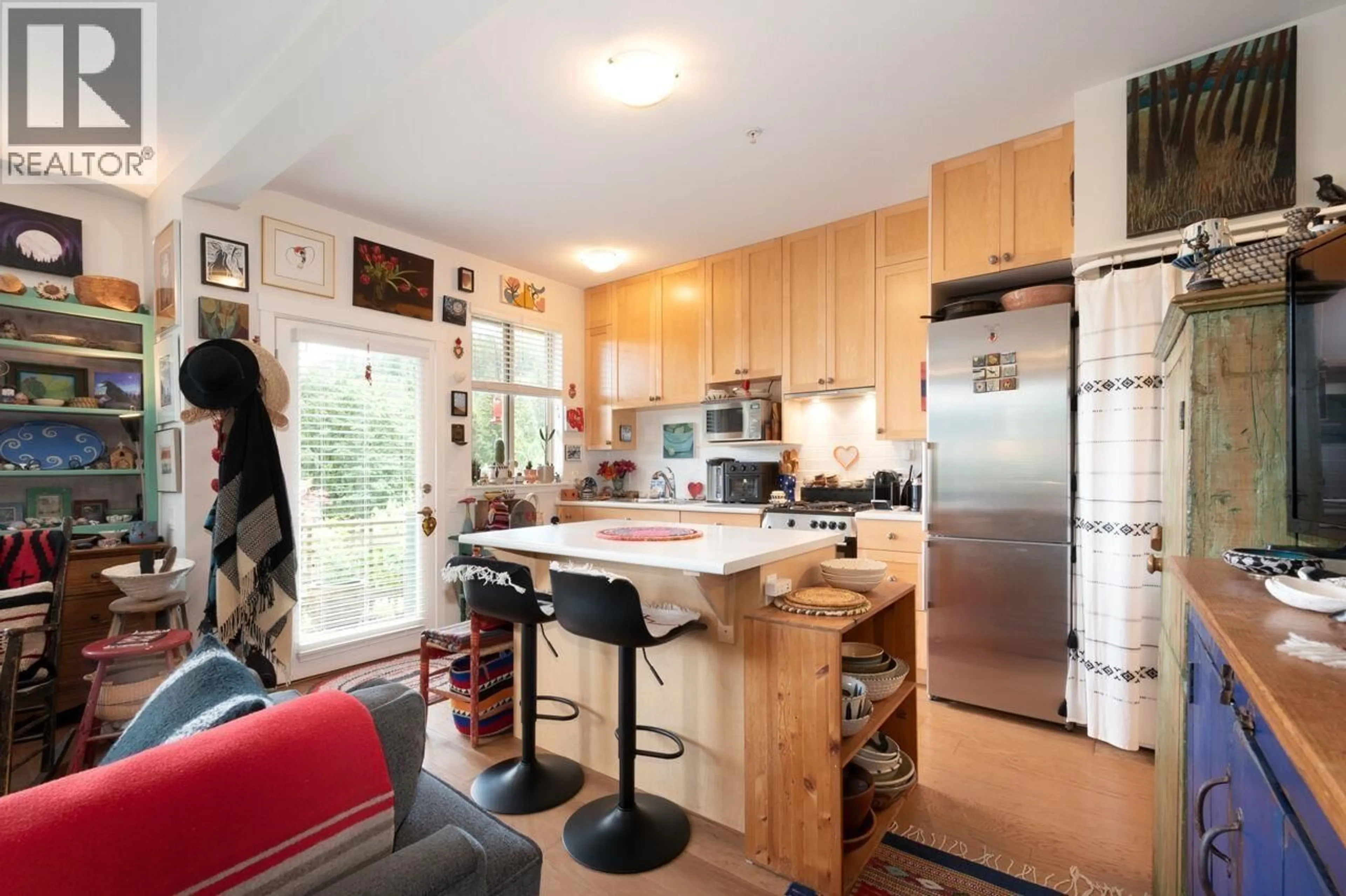 Open concept kitchen, wood/laminate floor for 207 - 726A BELTERRA ROAD, Bowen Island British Columbia V0N1G2