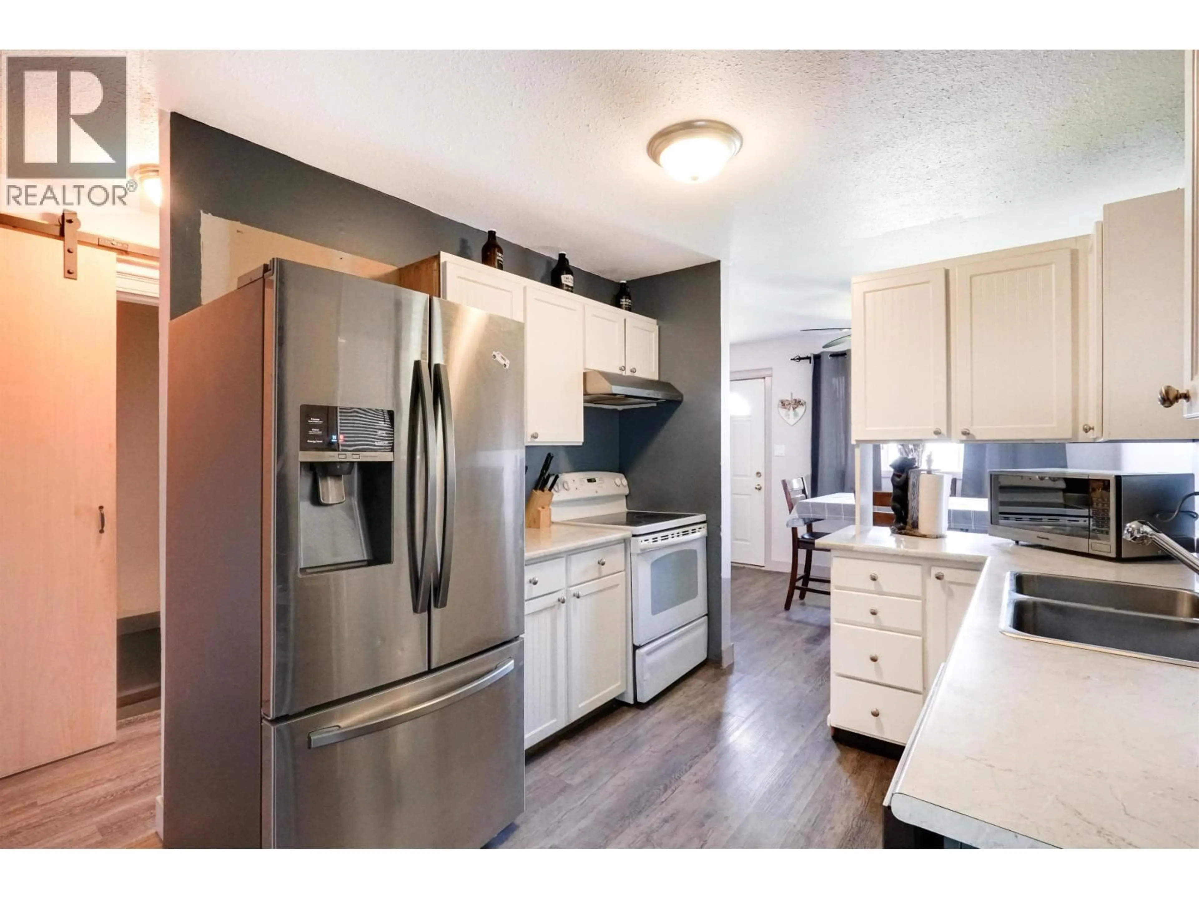 Open concept kitchen, wood/laminate floor for 16 CARSWELL STREET, Kitimat British Columbia V8C1B3