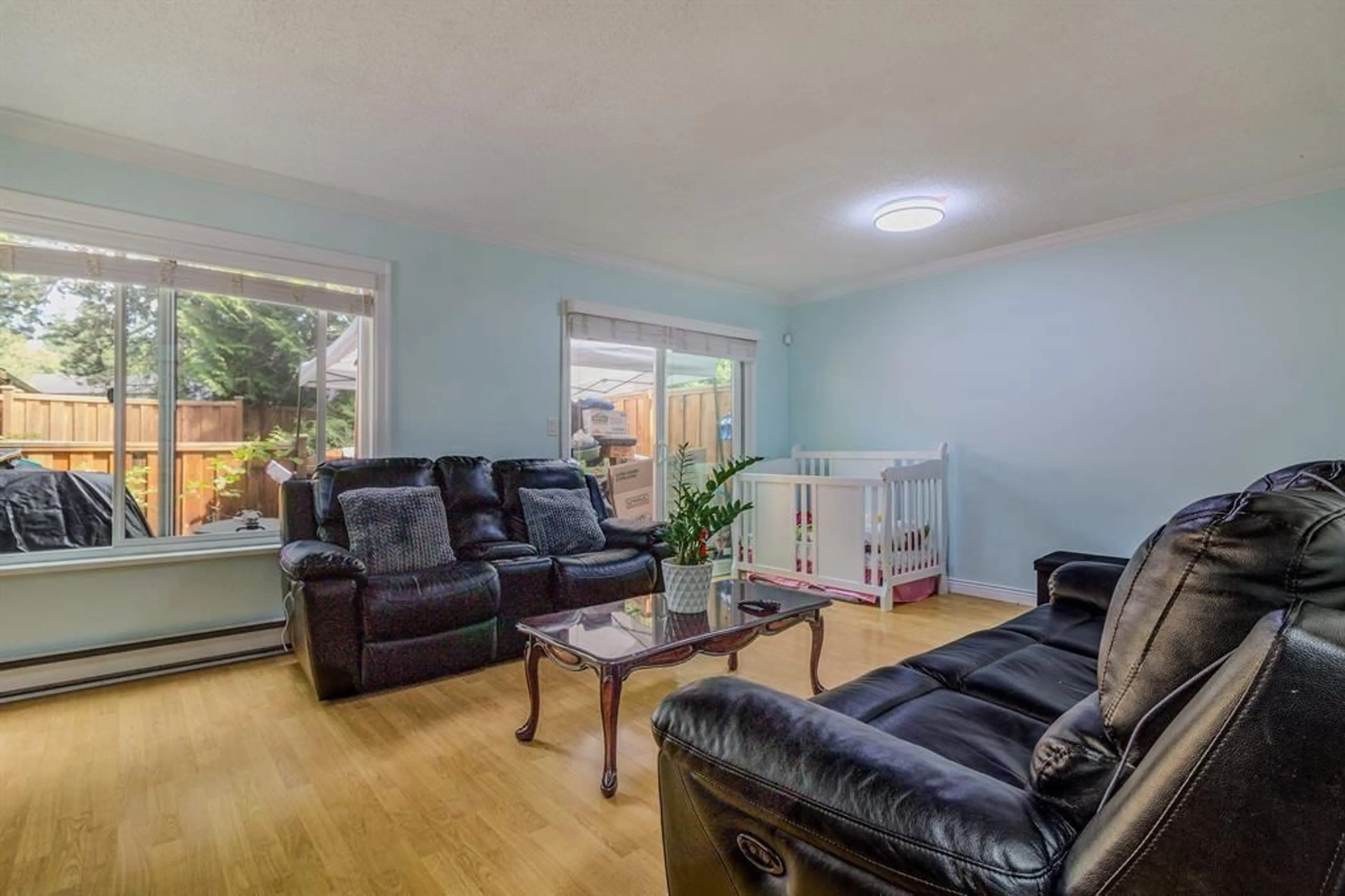 Living room with furniture, wood/laminate floor for 120 - 13880 74 AVENUE, Surrey British Columbia V3W7E6