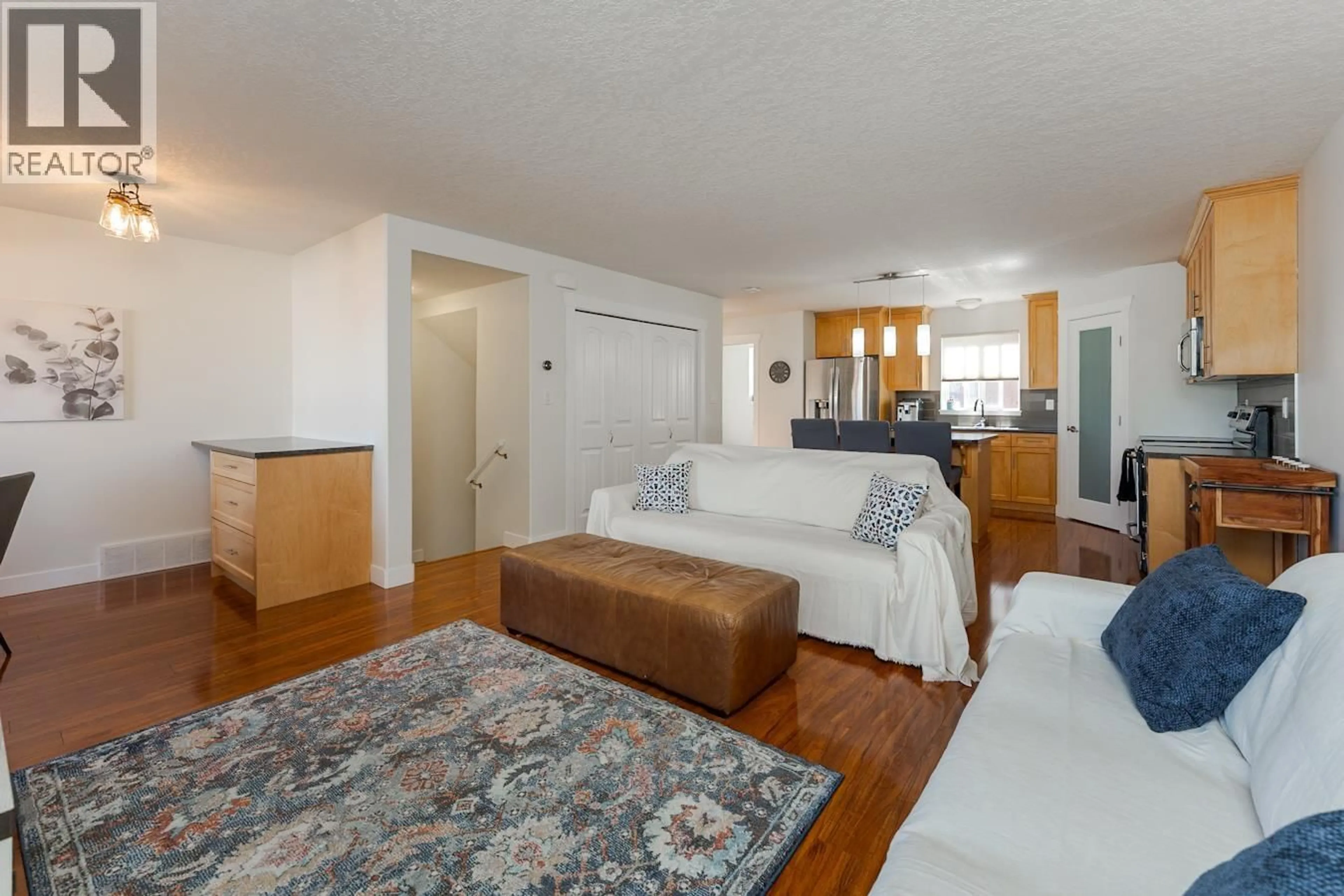 Living room with furniture, wood/laminate floor for 106 - 1699 7TH AVENUE, Prince George British Columbia V2L0C1