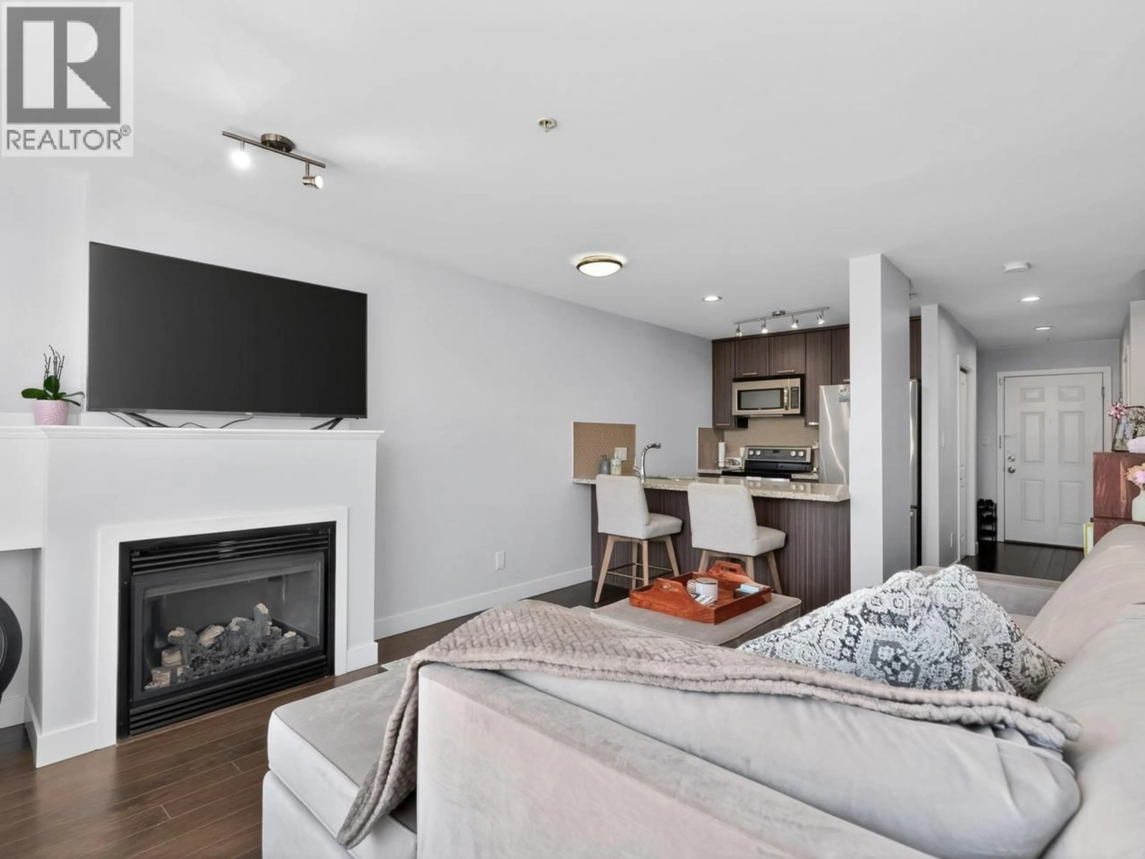 Living room with furniture, wood/laminate floor for 411 - 3255 SMITH AVENUE, Burnaby British Columbia V5G0B5