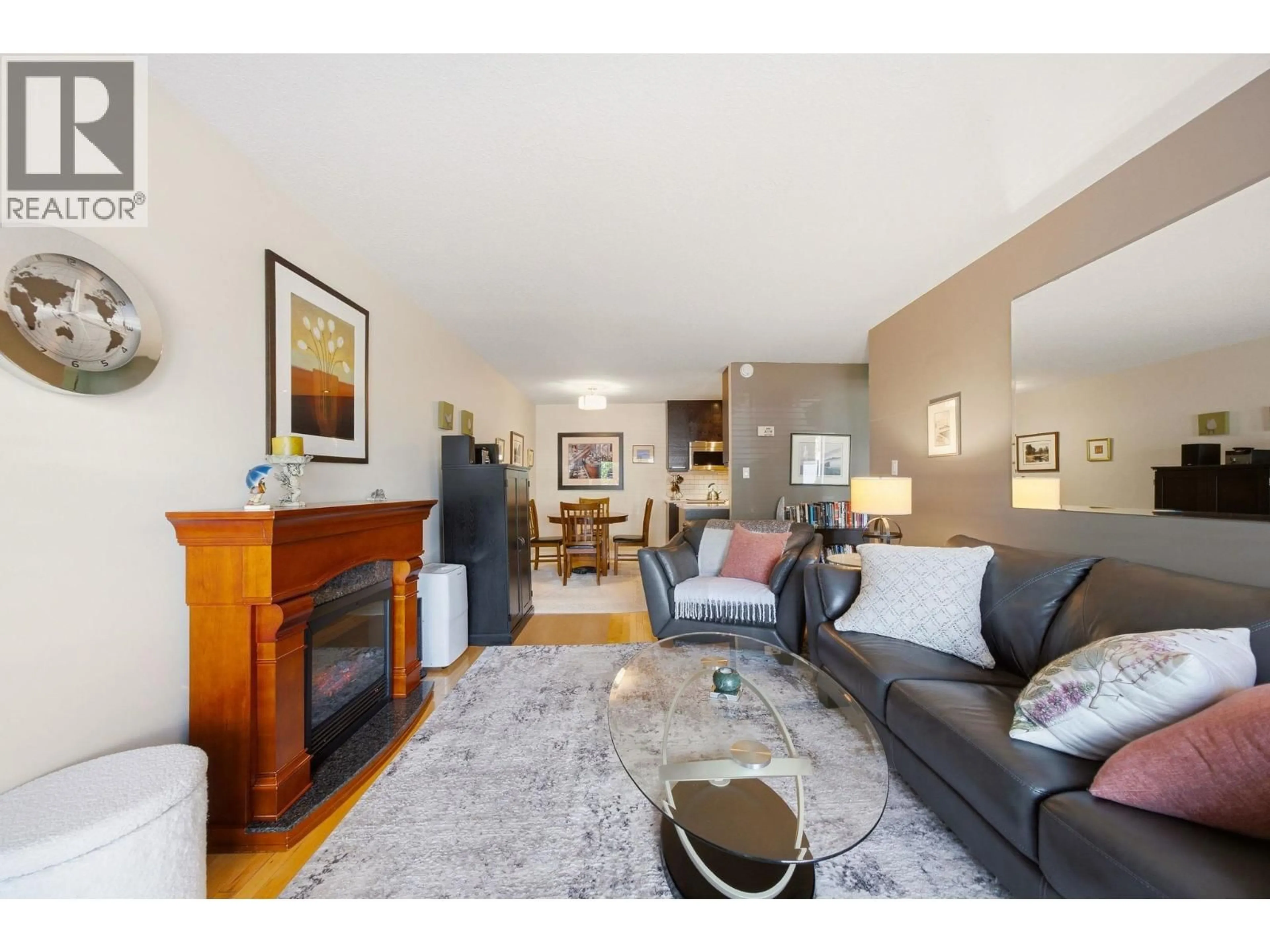 Living room with furniture, wood/laminate floor for 101 - 123 19TH STREET, North Vancouver British Columbia V7L2Y9