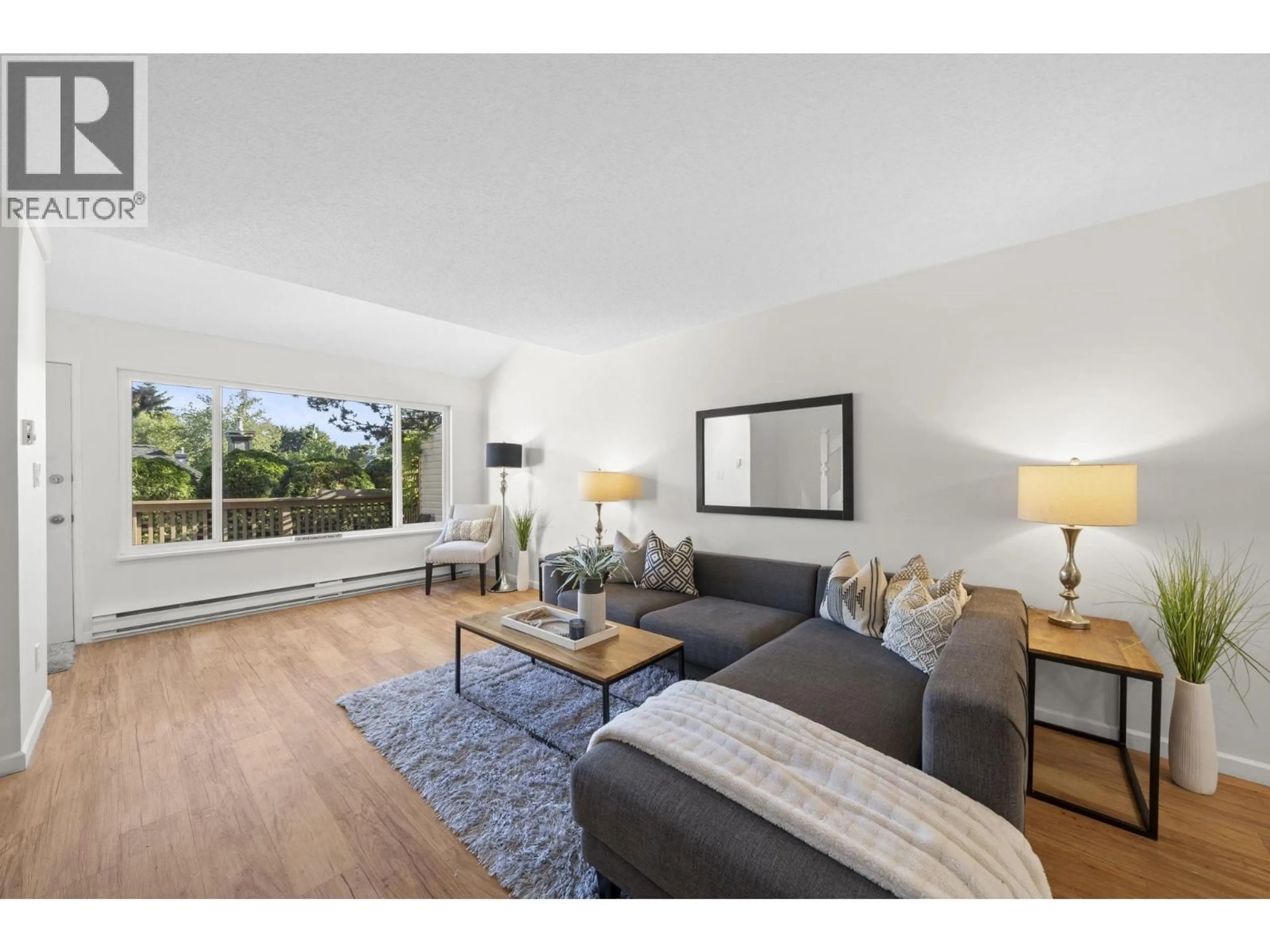 Living room with furniture, wood/laminate floor for 4896 47A AVENUE, Delta British Columbia V4K1T4