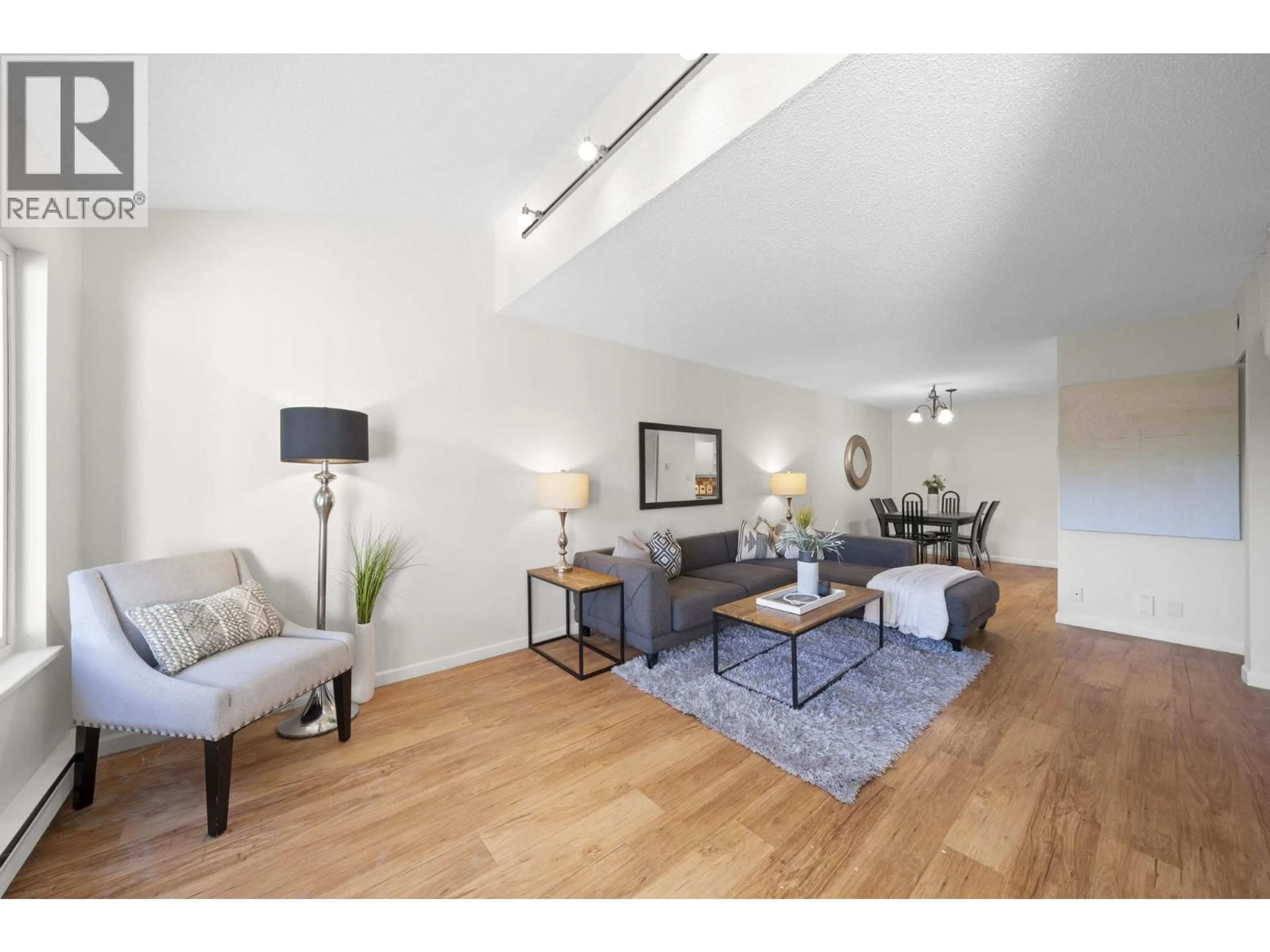 Living room with furniture, wood/laminate floor for 4896 47A AVENUE, Delta British Columbia V4K1T4