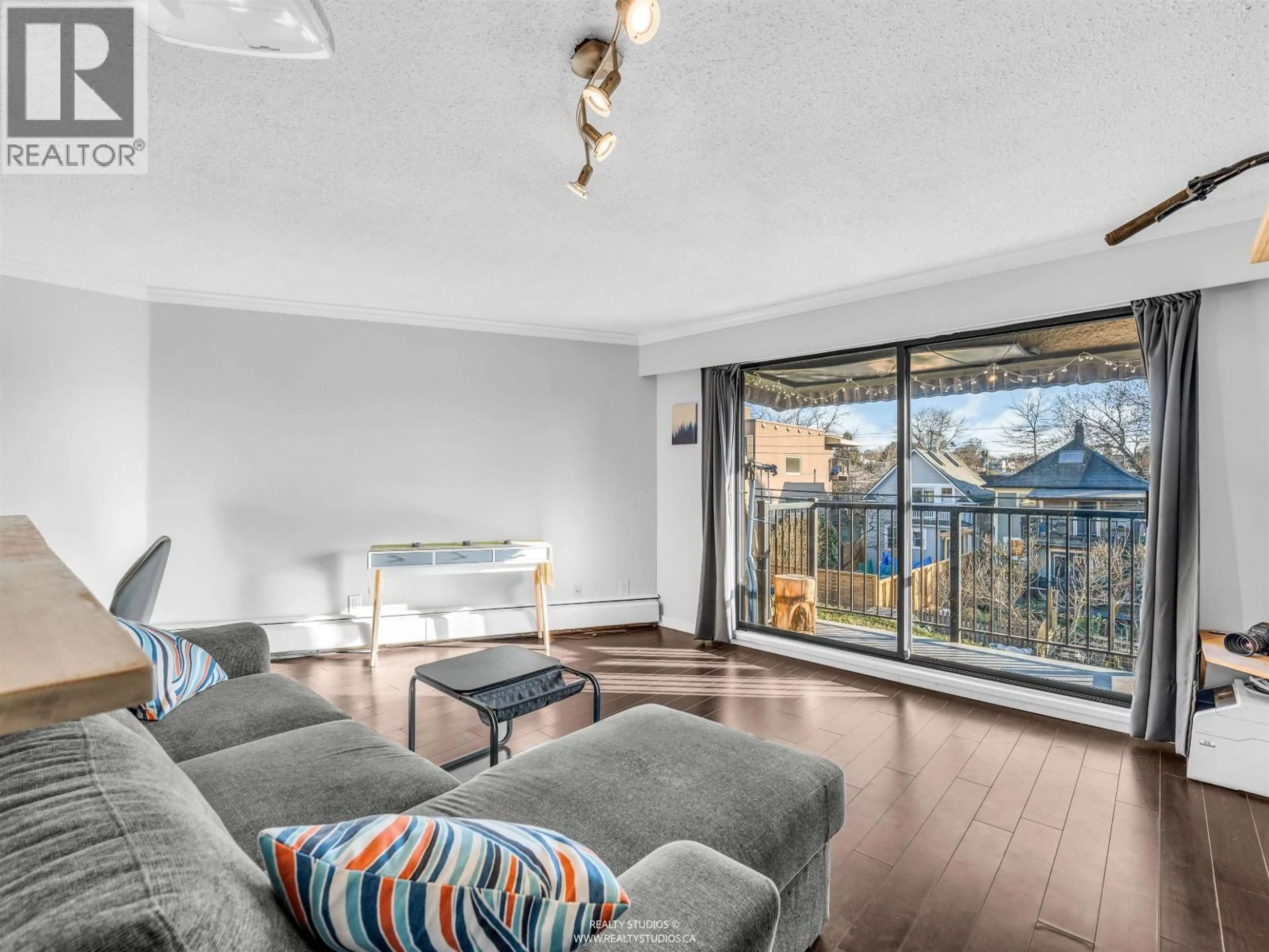 Living room with furniture, wood/laminate floor for 306 - 2222 CAMBRIDGE STREET, Vancouver British Columbia V5L1E6