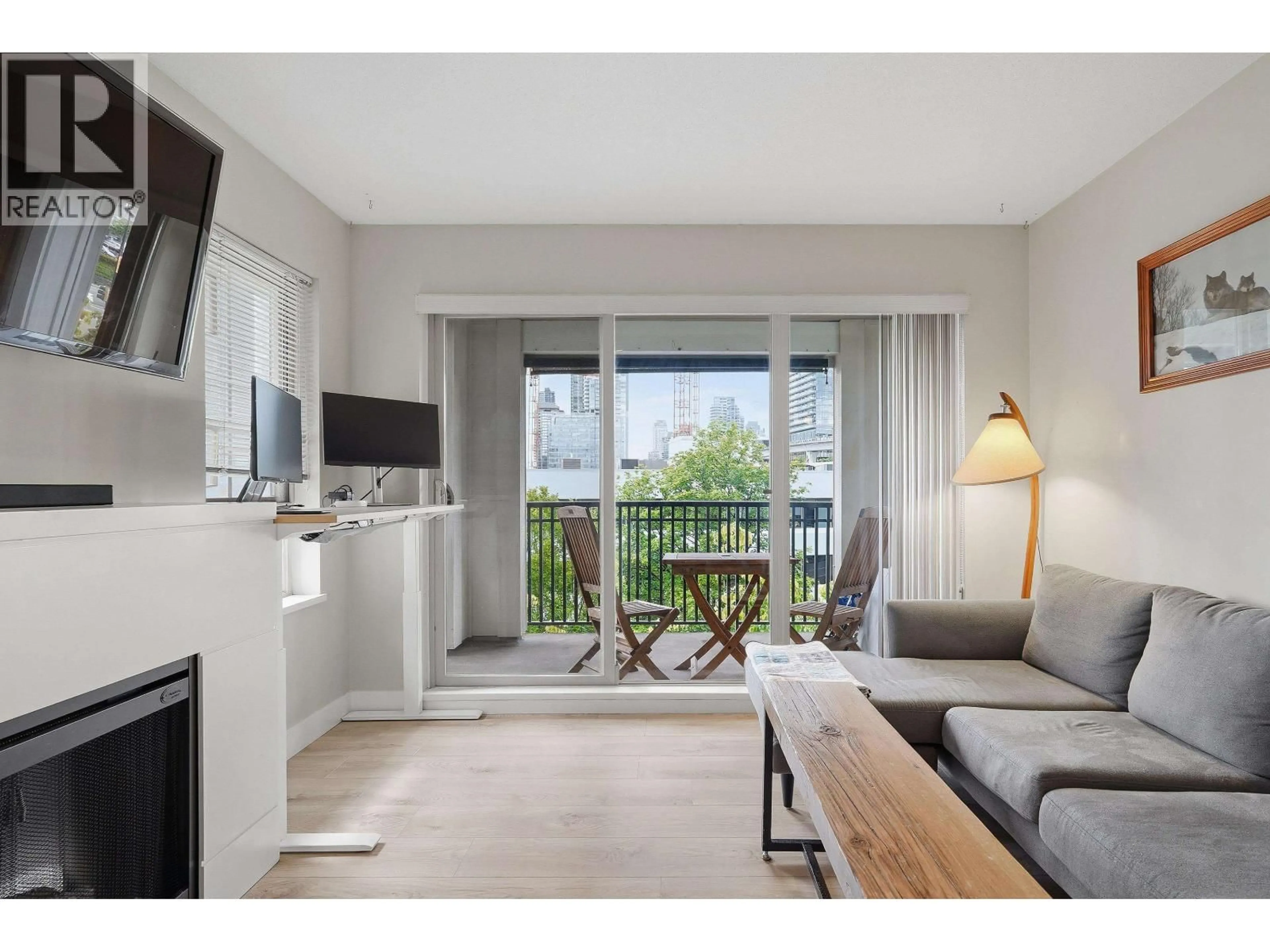 Living room with furniture, wood/laminate floor for 403 - 2088 BETA AVENUE, Burnaby British Columbia V5C0C8