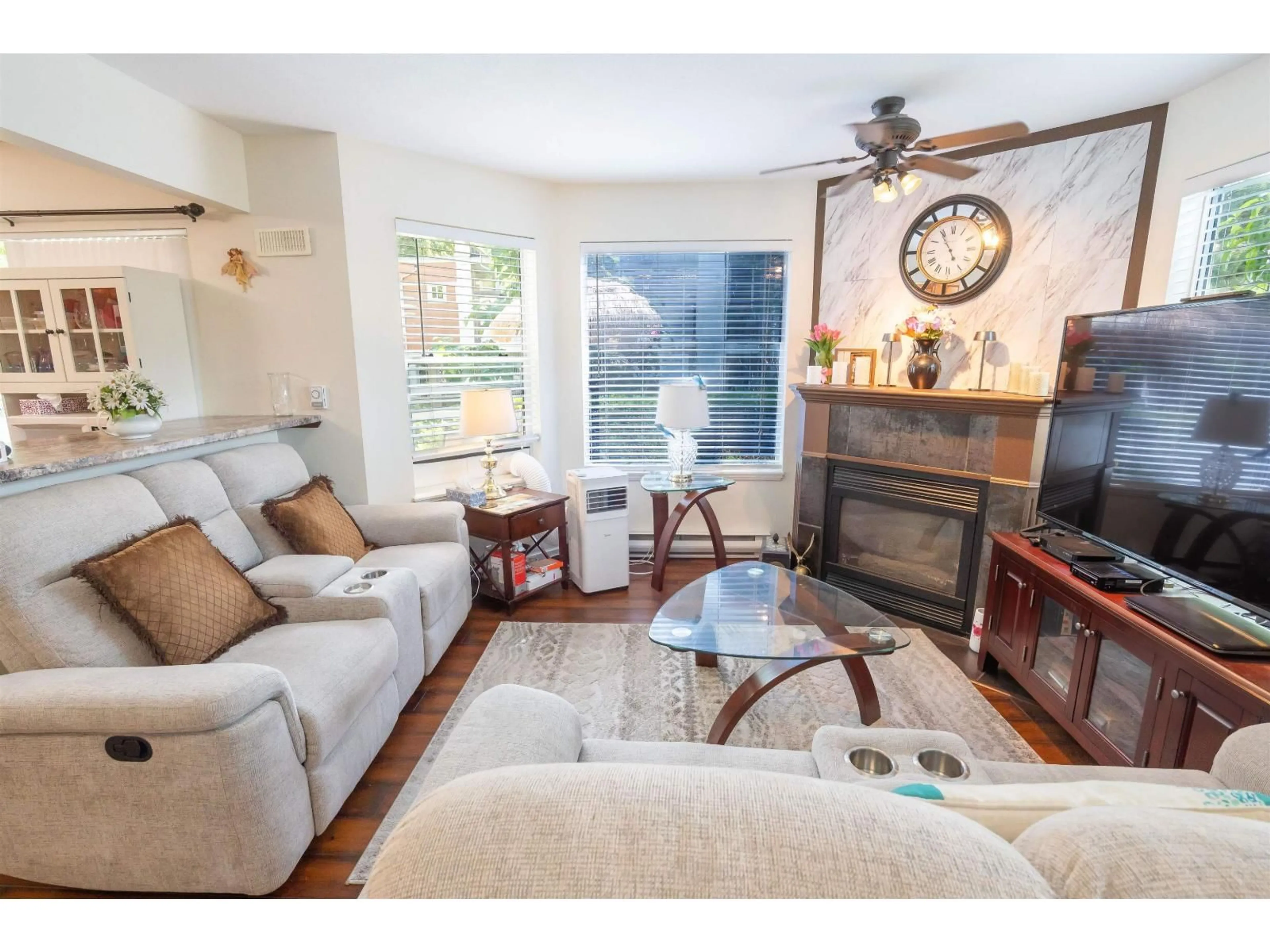 Living room with furniture, wood/laminate floor for 109 - 7554 BRISKHAM STREET, Mission British Columbia V2V3L9