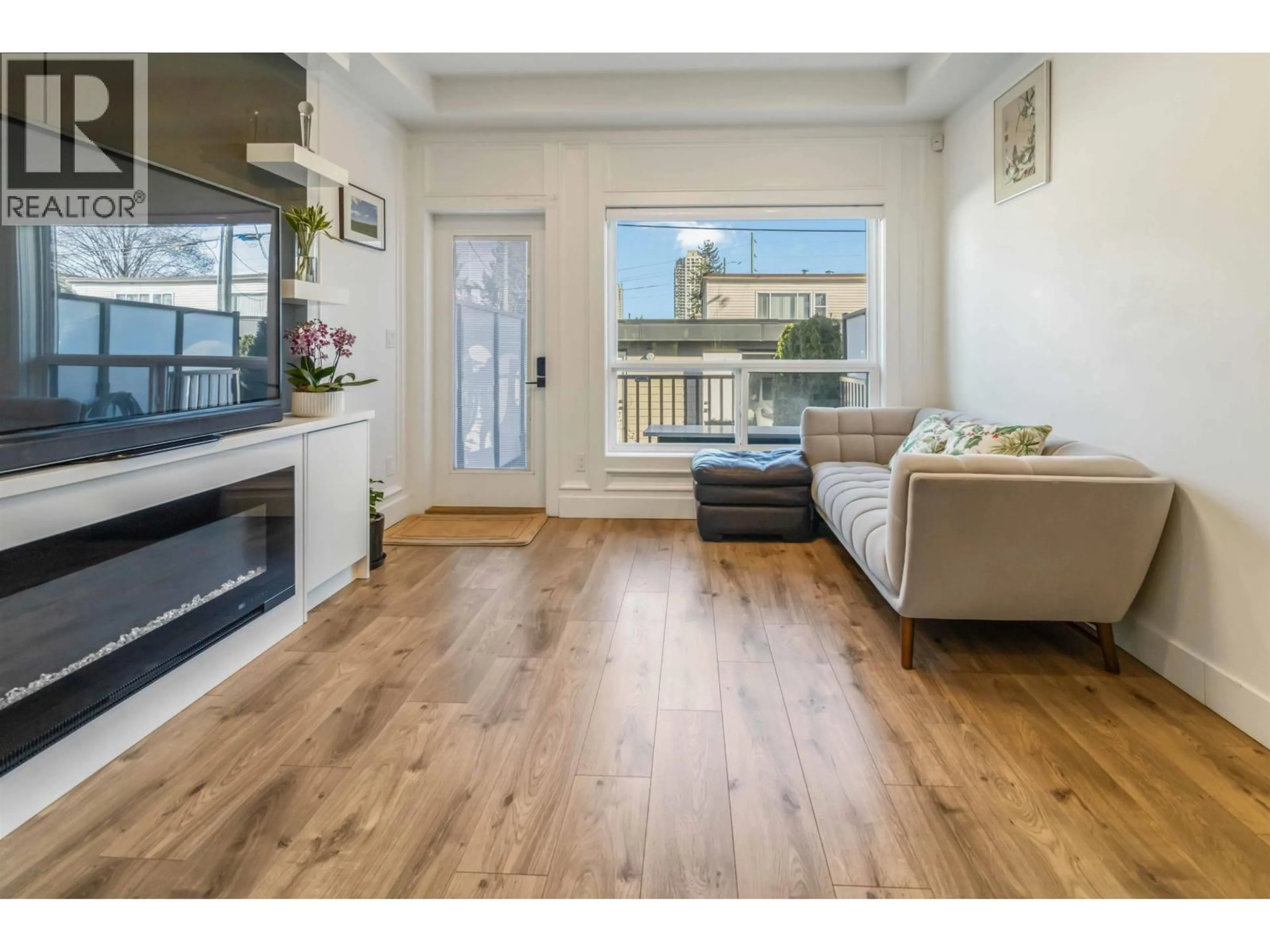 Living room with furniture, wood/laminate floor for 102 - 7088 SPERLING AVENUE, Burnaby British Columbia V5E2W3