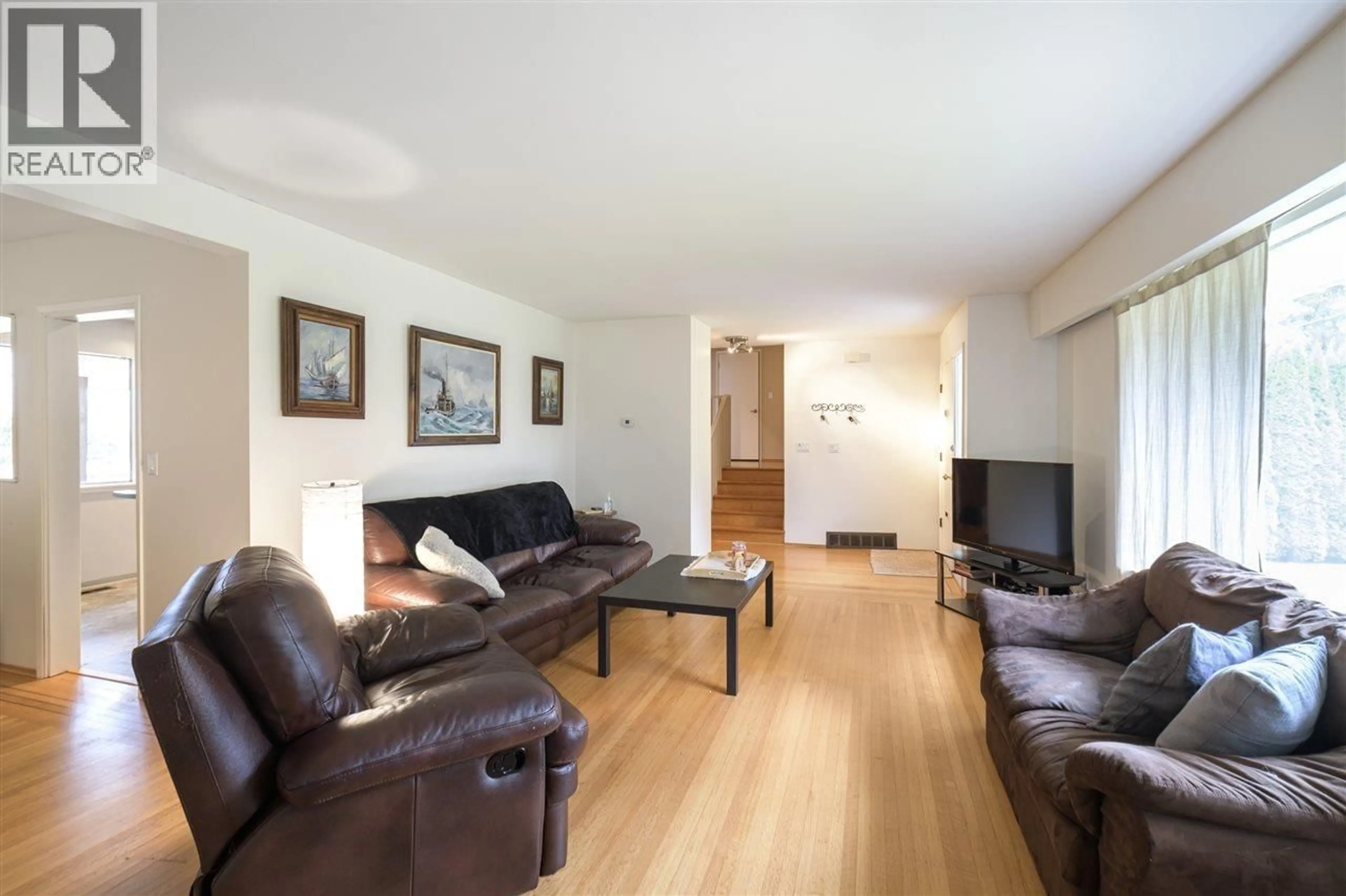 Living room with furniture, wood/laminate floor for 4965 8A AVENUE, Delta British Columbia V4M1T2