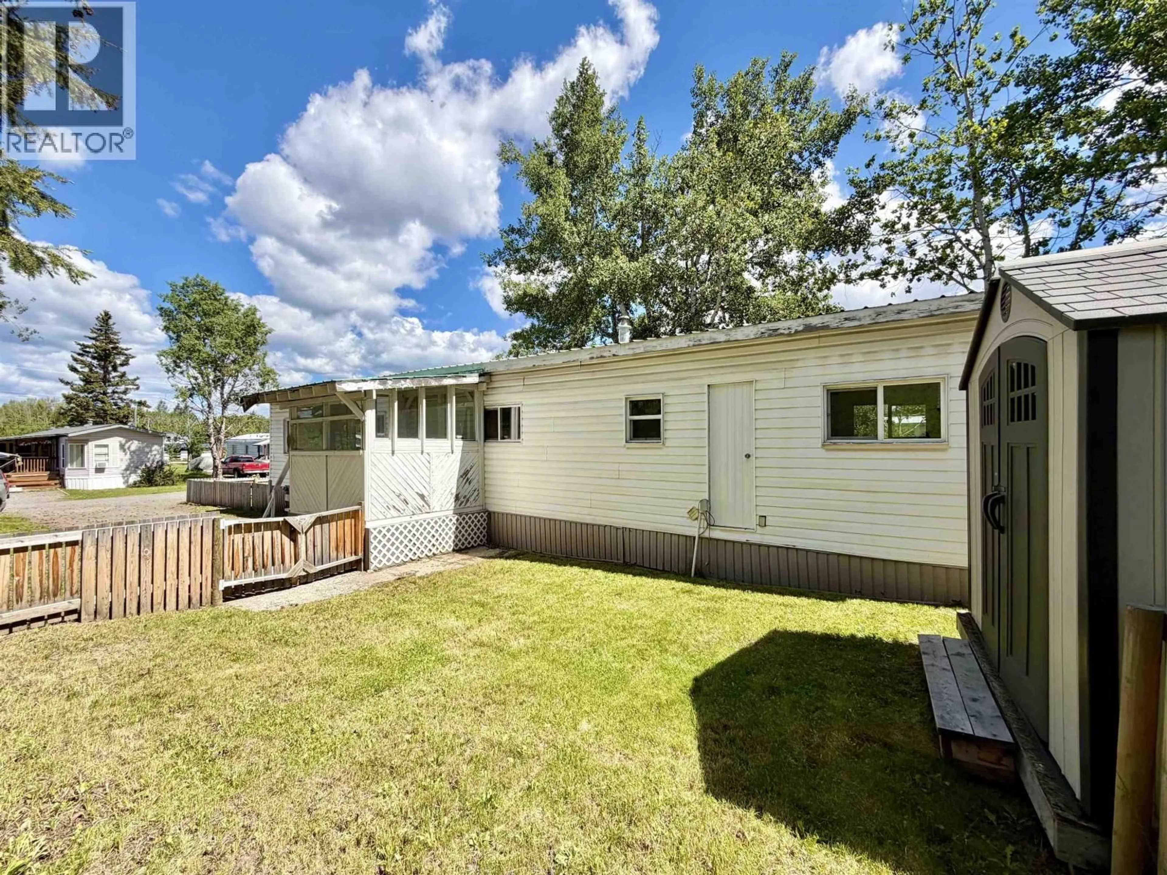 A pic from outside/outdoor area/front of a property/back of a property/a pic from drone, street for 10 - 5506 PARK DRIVE, 103 Mile House British Columbia V0K2E1
