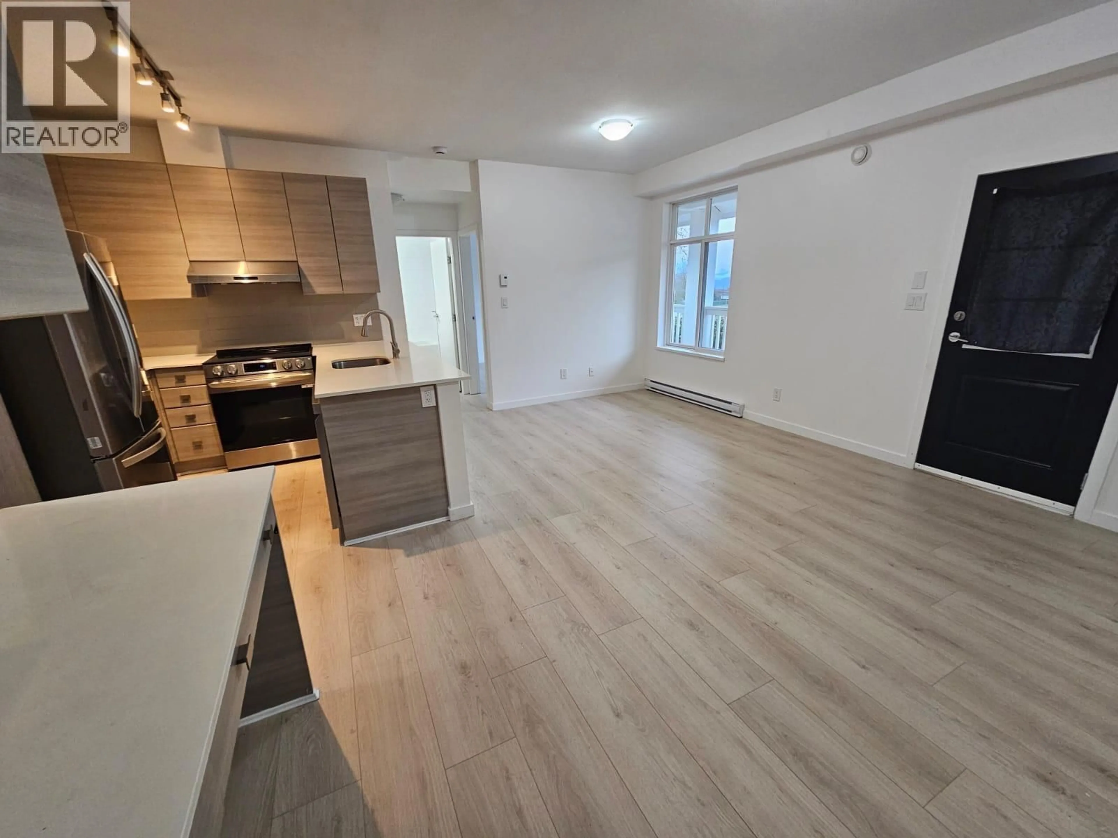 Open concept kitchen, wood/laminate floor for 32 - 6965 HASTINGS STREET, Burnaby British Columbia V5B1S9