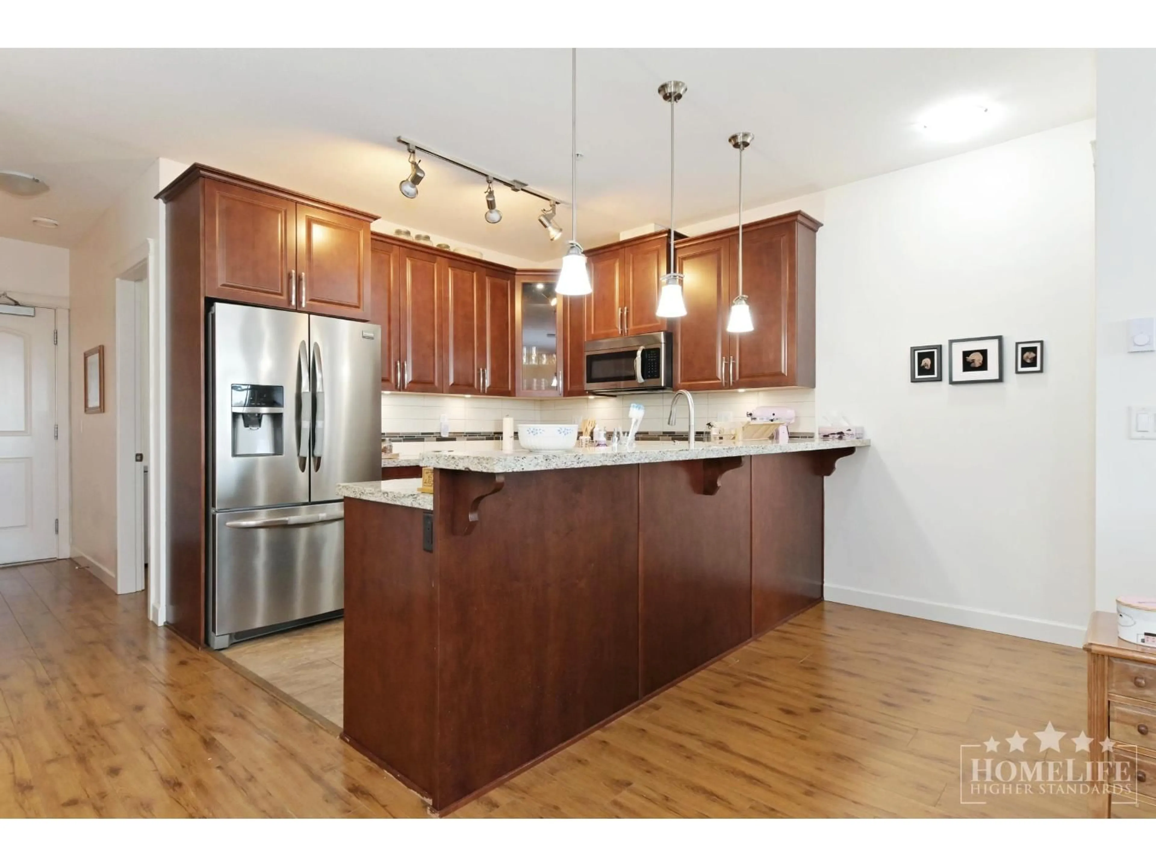 Open concept kitchen, wood/laminate floor for 528 - 8067 207 STREET, Langley British Columbia V2Y0P1