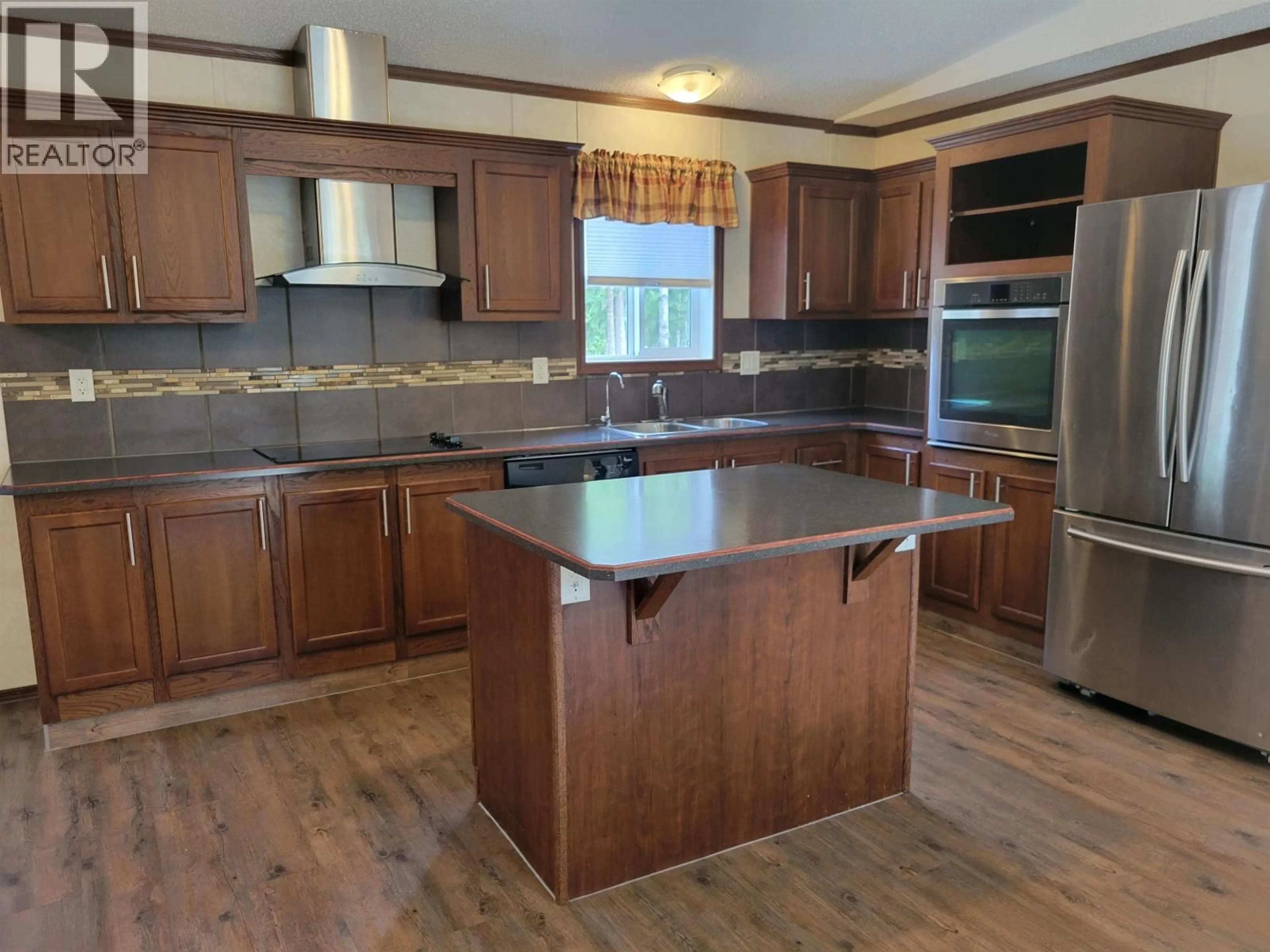 Open concept kitchen, wood/laminate floor for 314 NICHIPORUK ROAD, Vanderhoof British Columbia V0J3A1