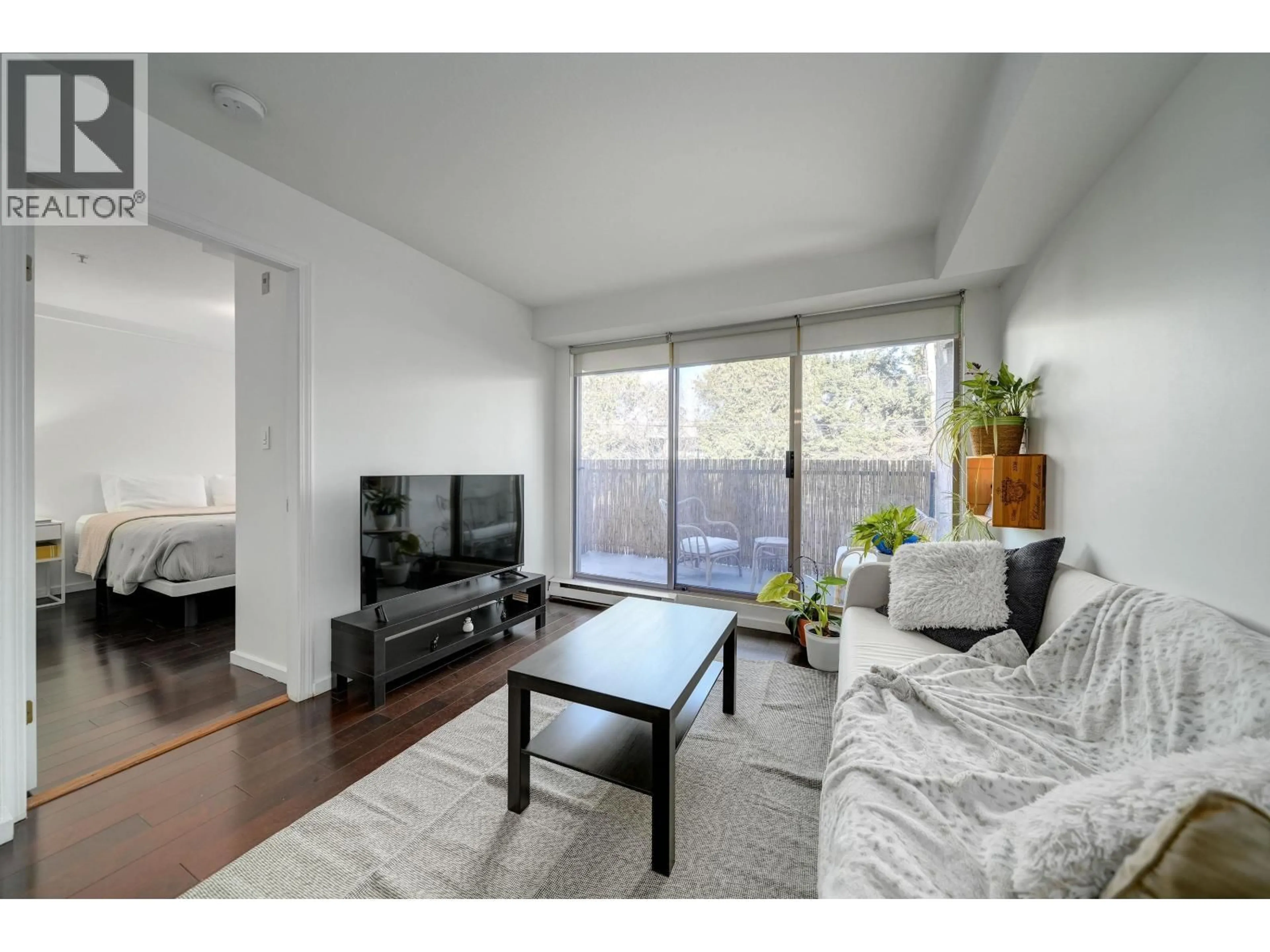 Living room with furniture, wood/laminate floor for 210 - 1099 BROADWAY, Vancouver British Columbia V5T1Y5