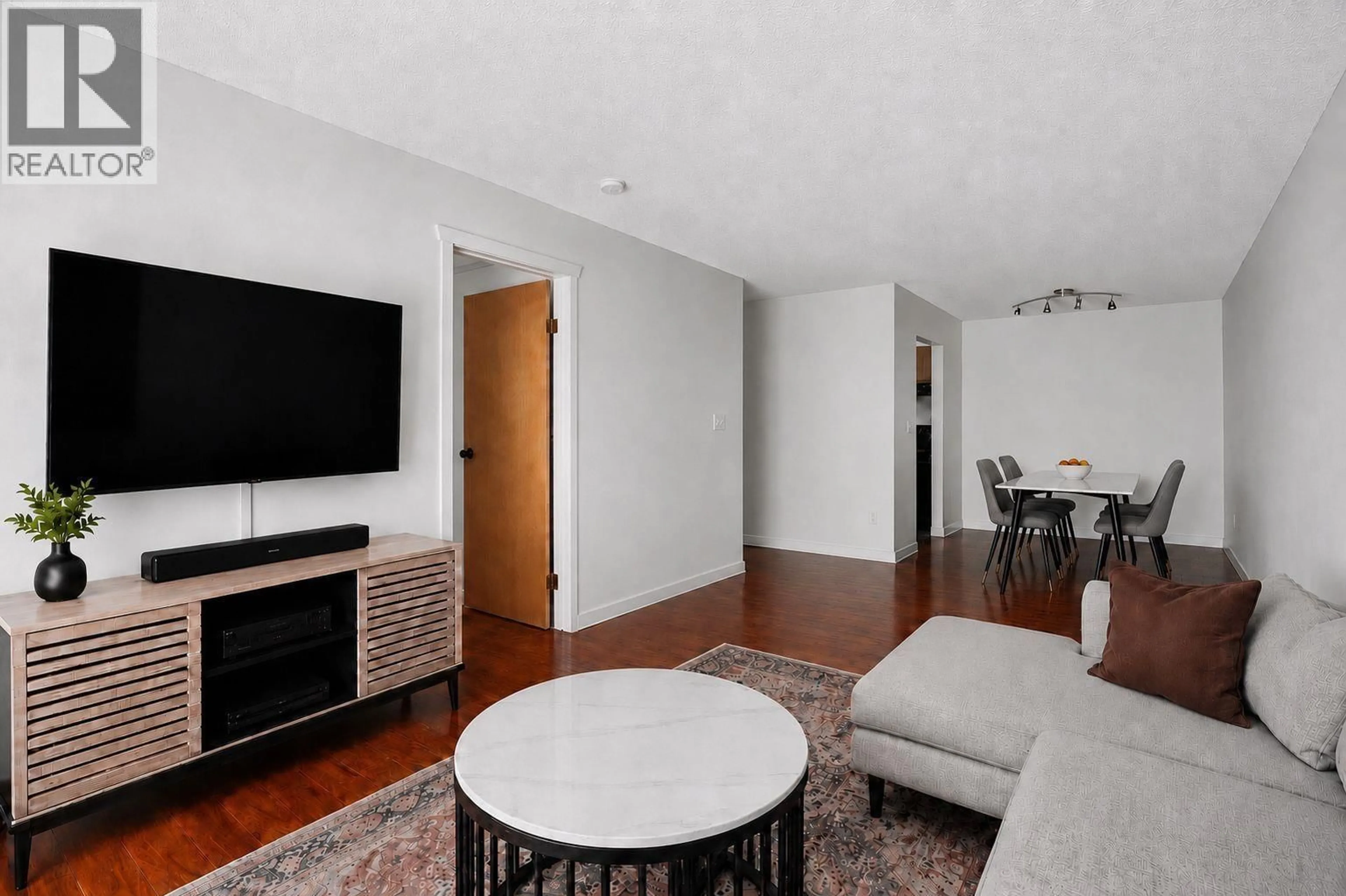 Living room with furniture, wood/laminate floor for 202 - 2328 OXFORD STREET, Vancouver British Columbia V5L1G3