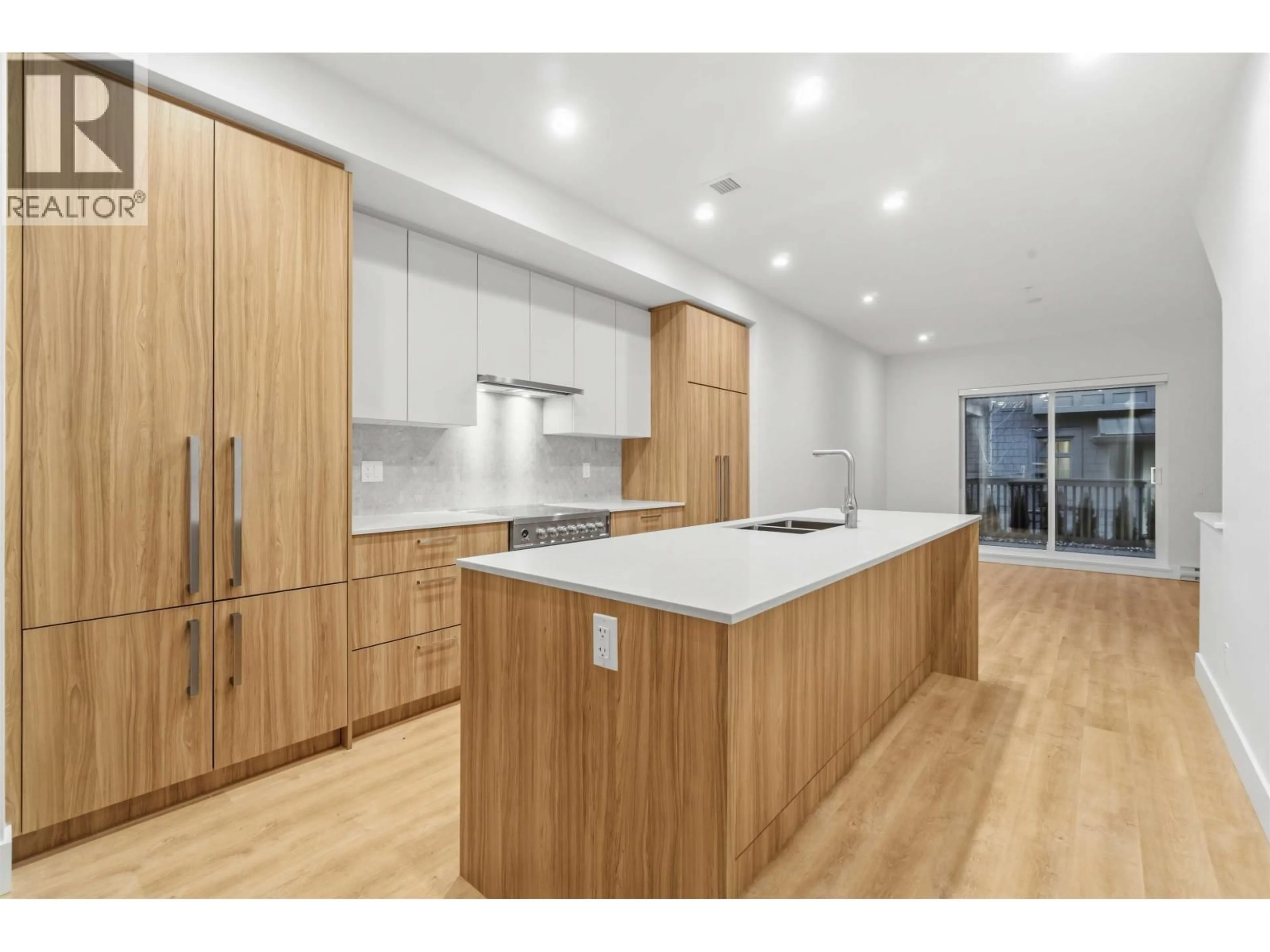 Open concept kitchen, wood/laminate floor for 107 - 2320 EMERY COURT, North Vancouver British Columbia V7J0G3