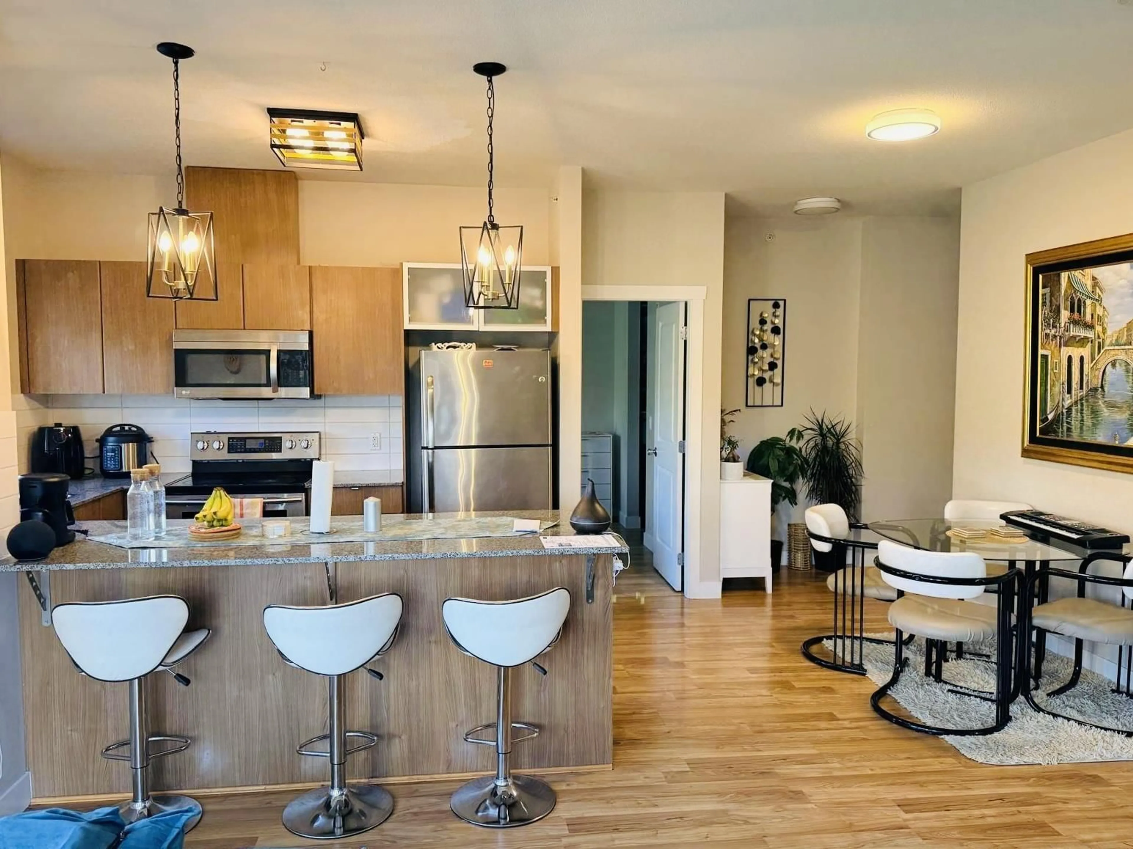 Open concept kitchen, wood/laminate floor for 419 - 9655 KING GEORGE BOULEVARD, Surrey British Columbia V3T0C7