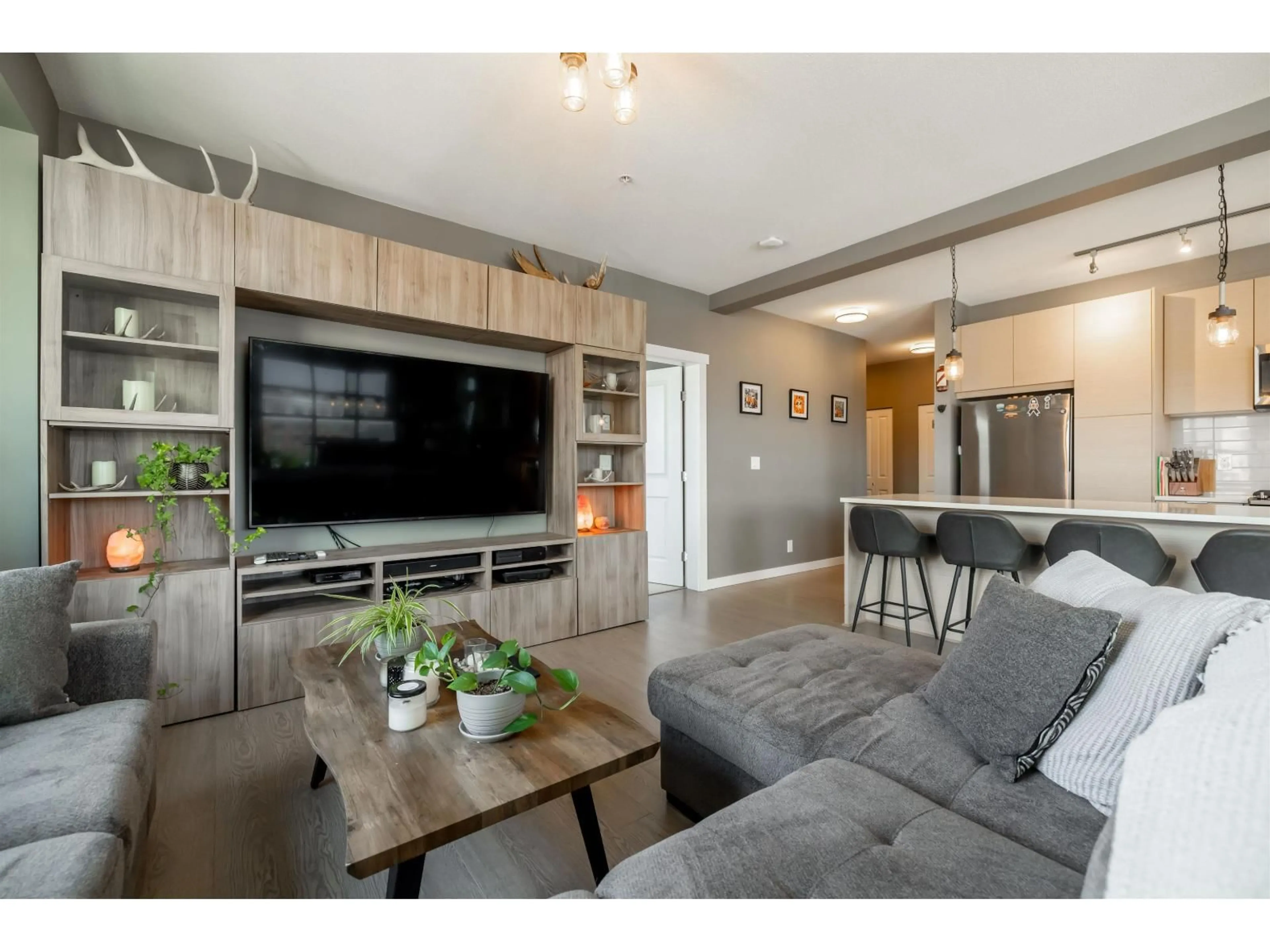Living room with furniture, wood/laminate floor for C307 - 8150 207 STREET, Langley British Columbia V2Y4J4
