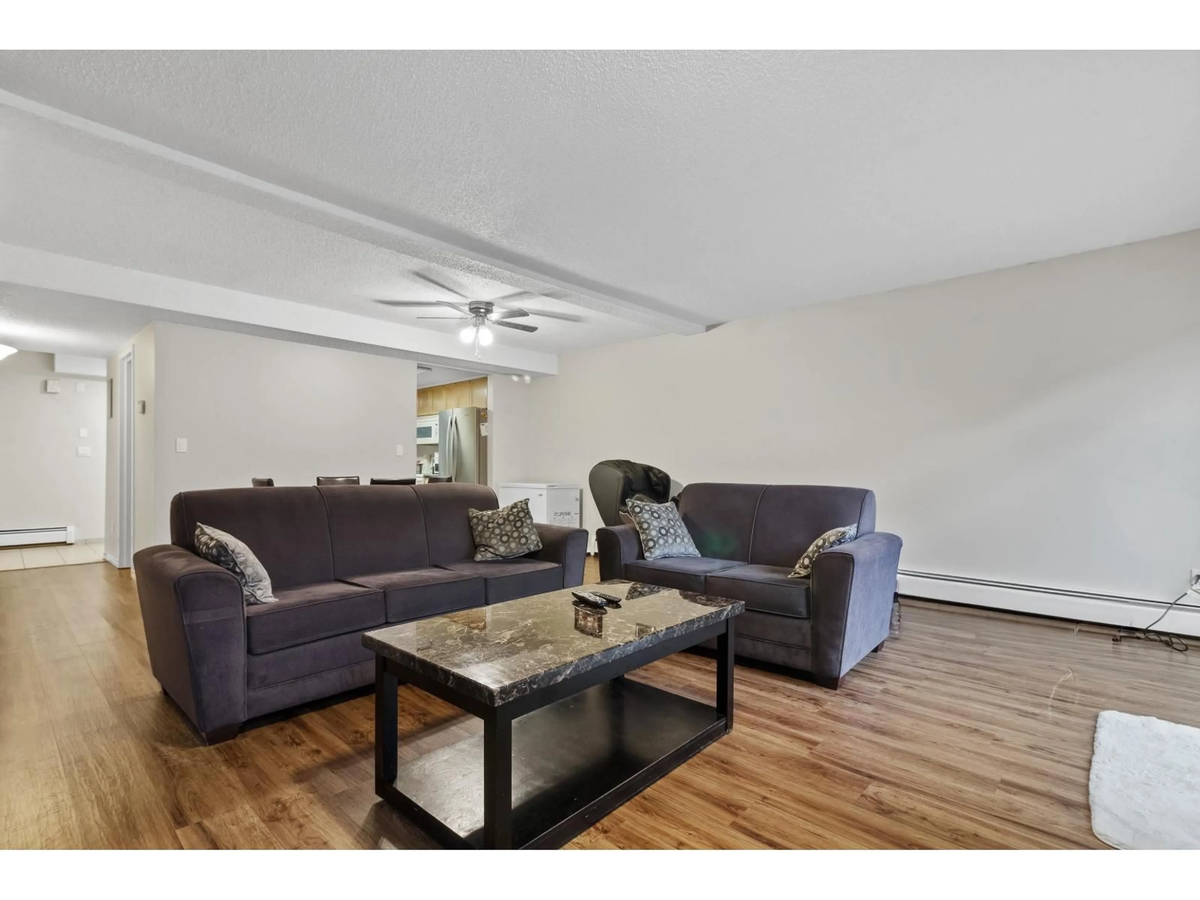 Living room with furniture, wood/laminate floor for 223 - 7453 140 STREET, Surrey British Columbia V3W6G5