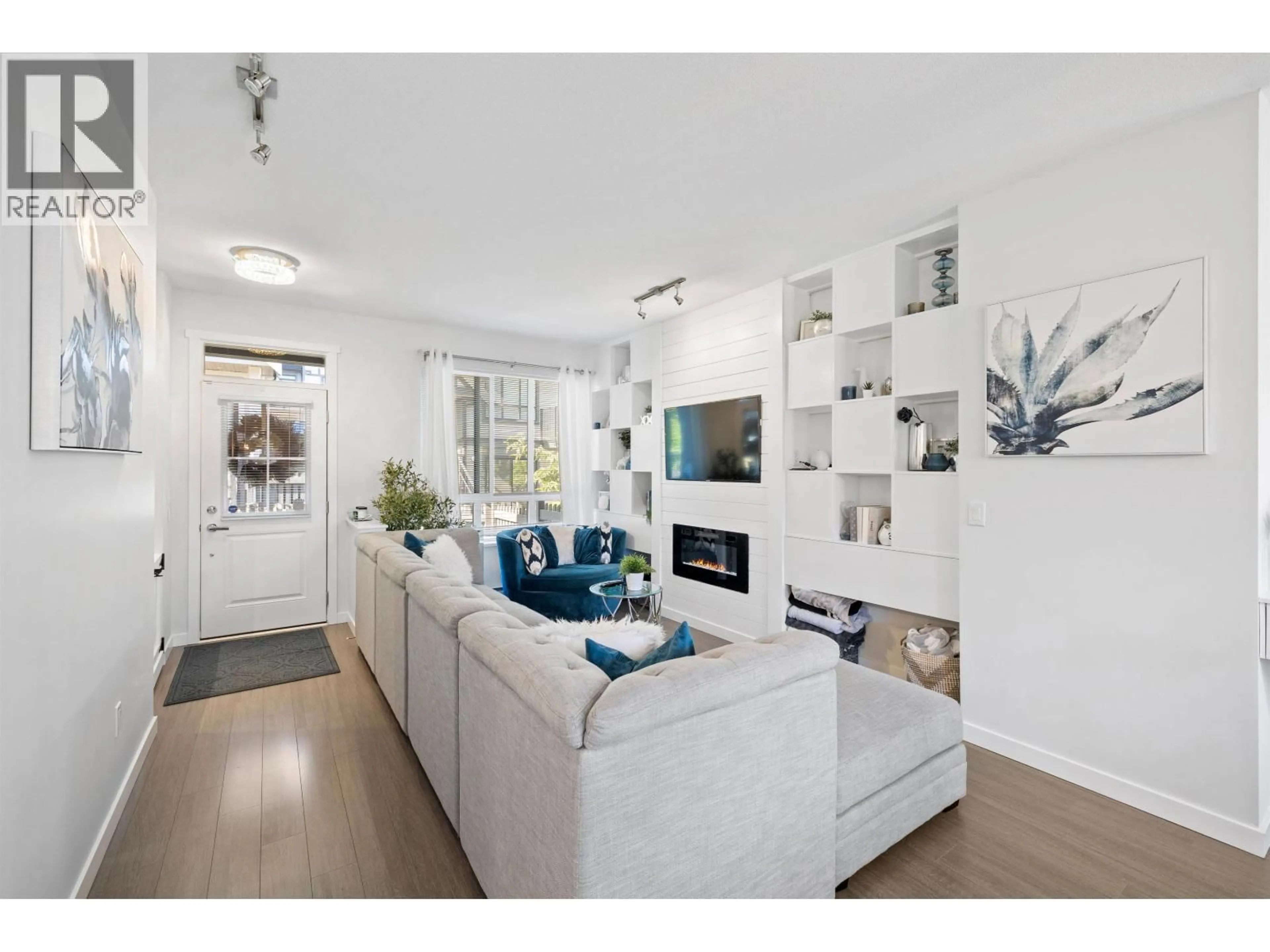 Living room with furniture, wood/laminate floor for 149 - 3500 BURKE VILLAGE PROMENADE, Coquitlam British Columbia V3E0N2