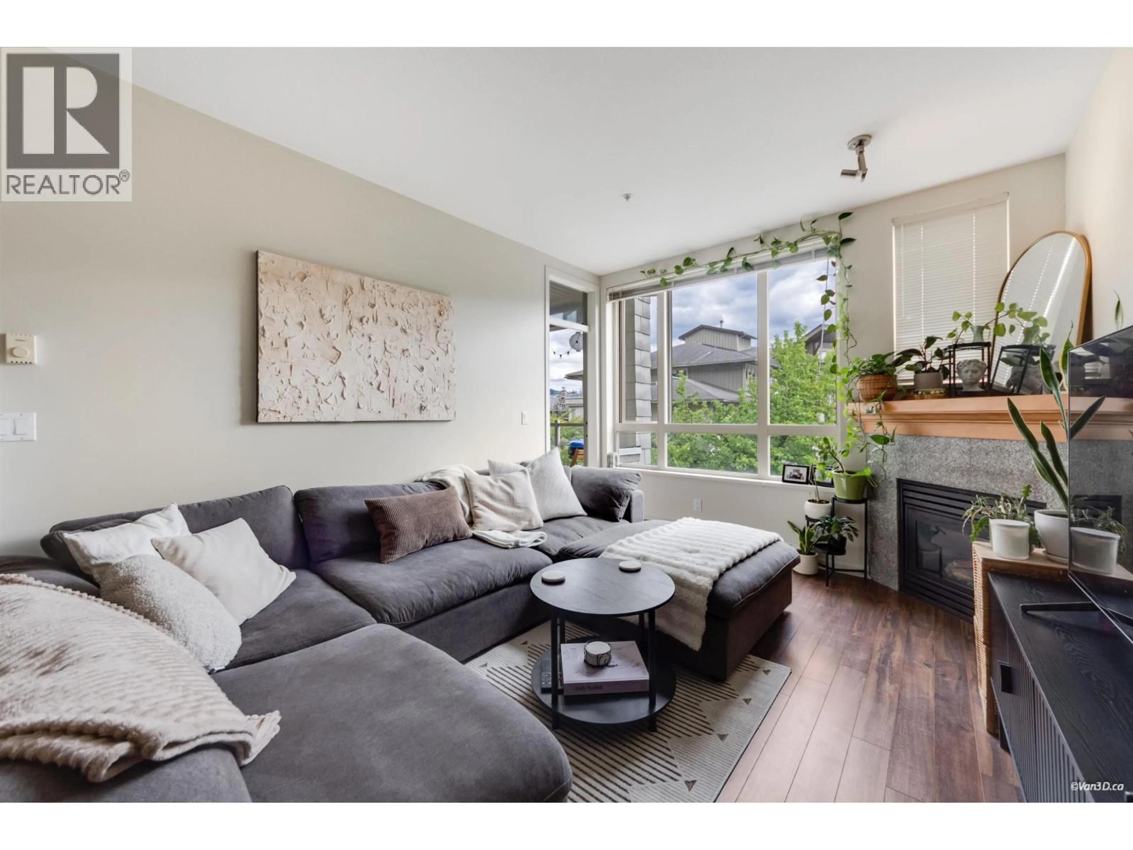 Living room with furniture, wood/laminate floor for 319 - 580 RAVEN WOODS DRIVE, North Vancouver British Columbia V7R3P4