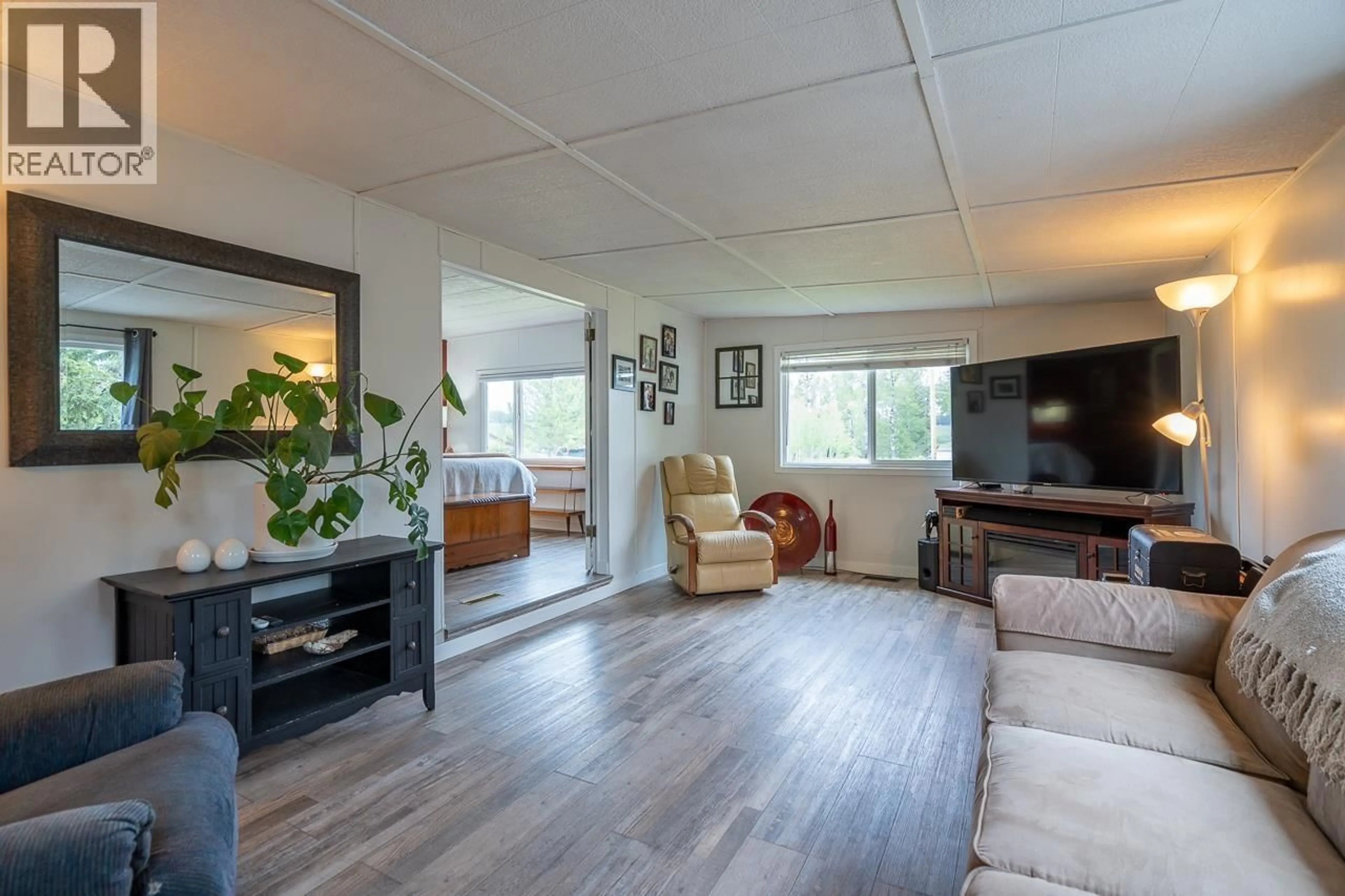 Living room with furniture, wood/laminate floor for 5166 WATSON LAKE ROAD, 100 Mile House British Columbia V0K2E1
