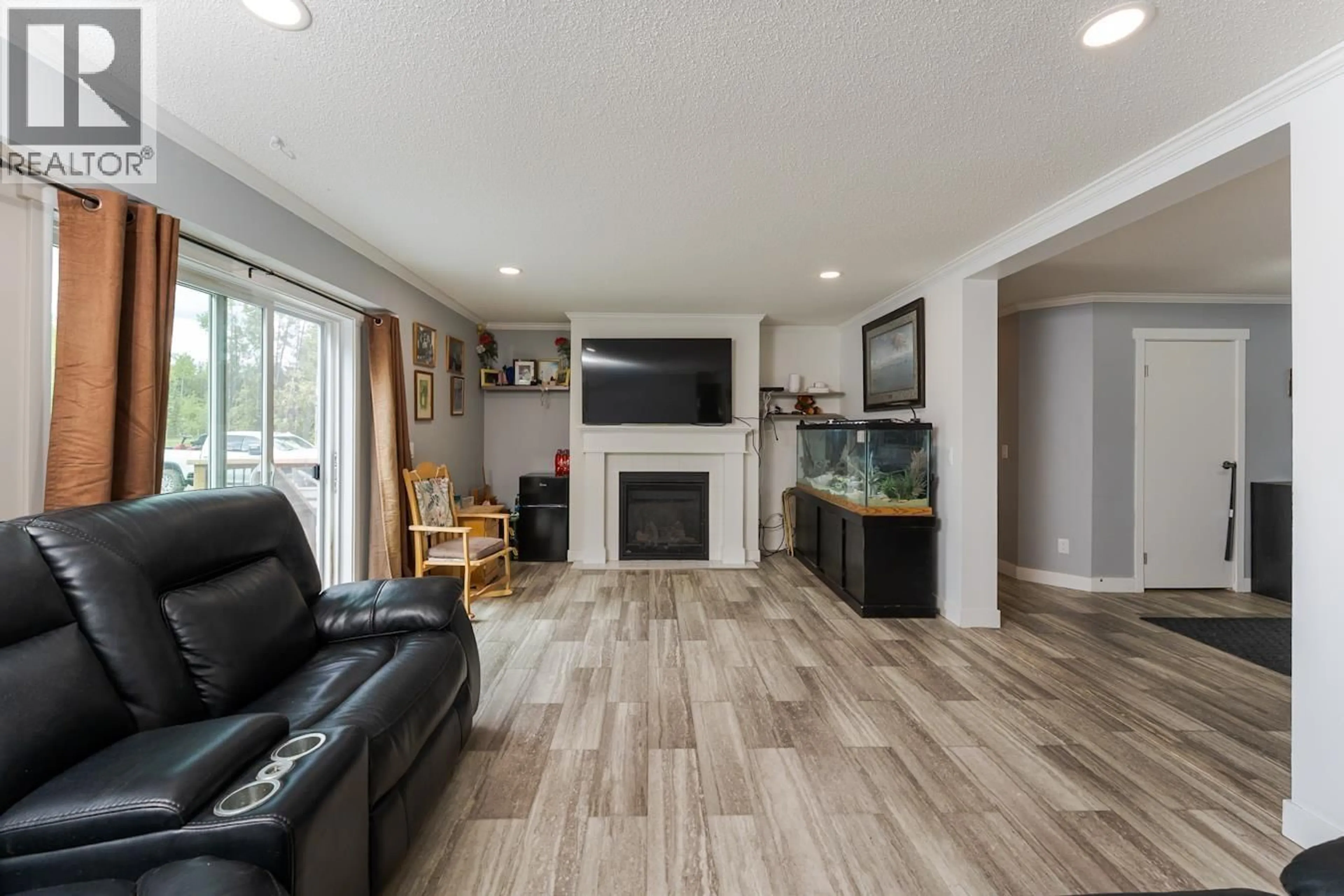 Living room with furniture, wood/laminate floor for 7825 LARSON ROAD, Prince George British Columbia V2N6S1