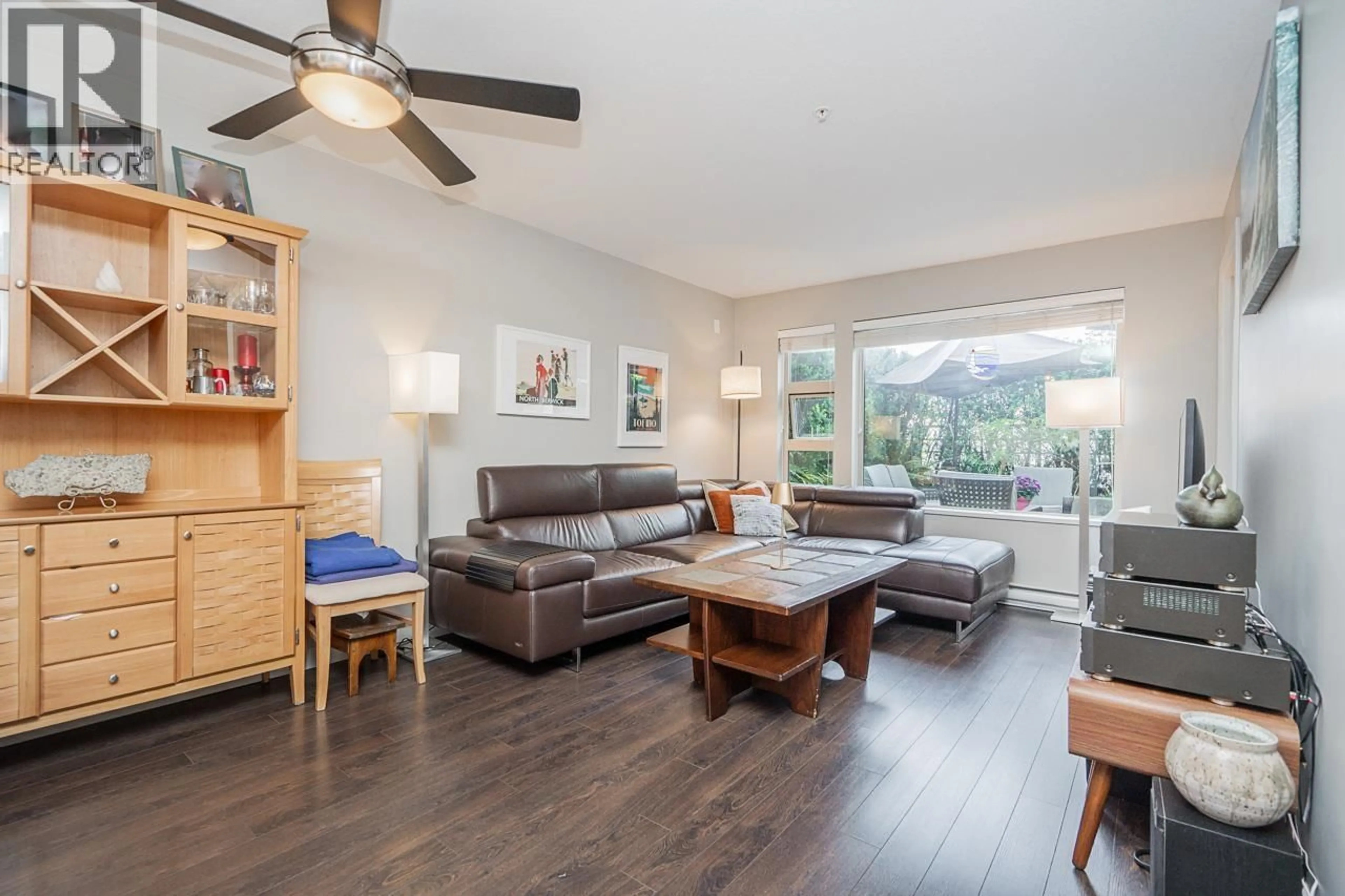 Living room with furniture, wood/laminate floor for 207 - 1677 LLOYD AVENUE, North Vancouver British Columbia V7P0B1