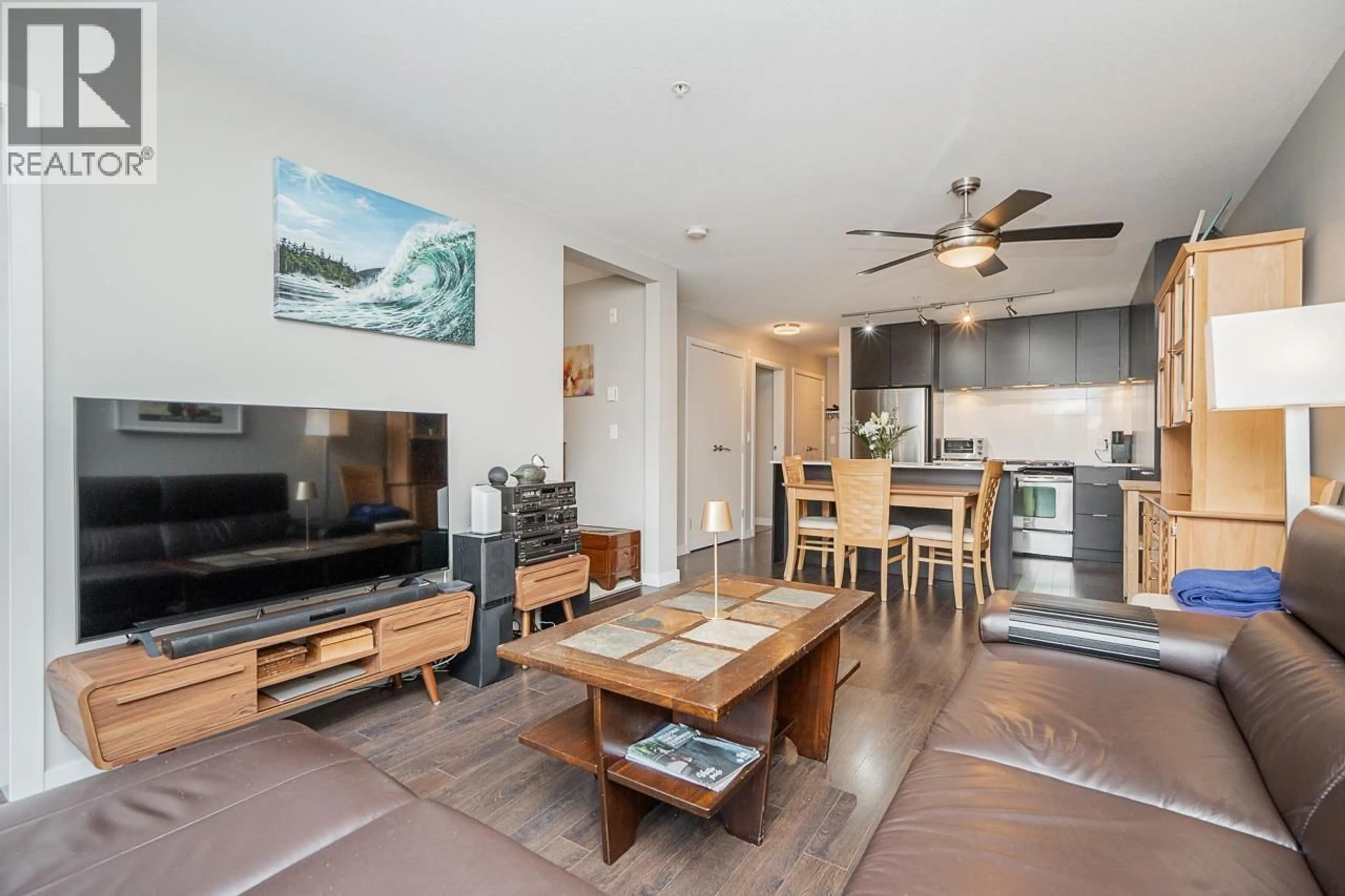 Living room with furniture, wood/laminate floor for 207 - 1677 LLOYD AVENUE, North Vancouver British Columbia V7P0B1