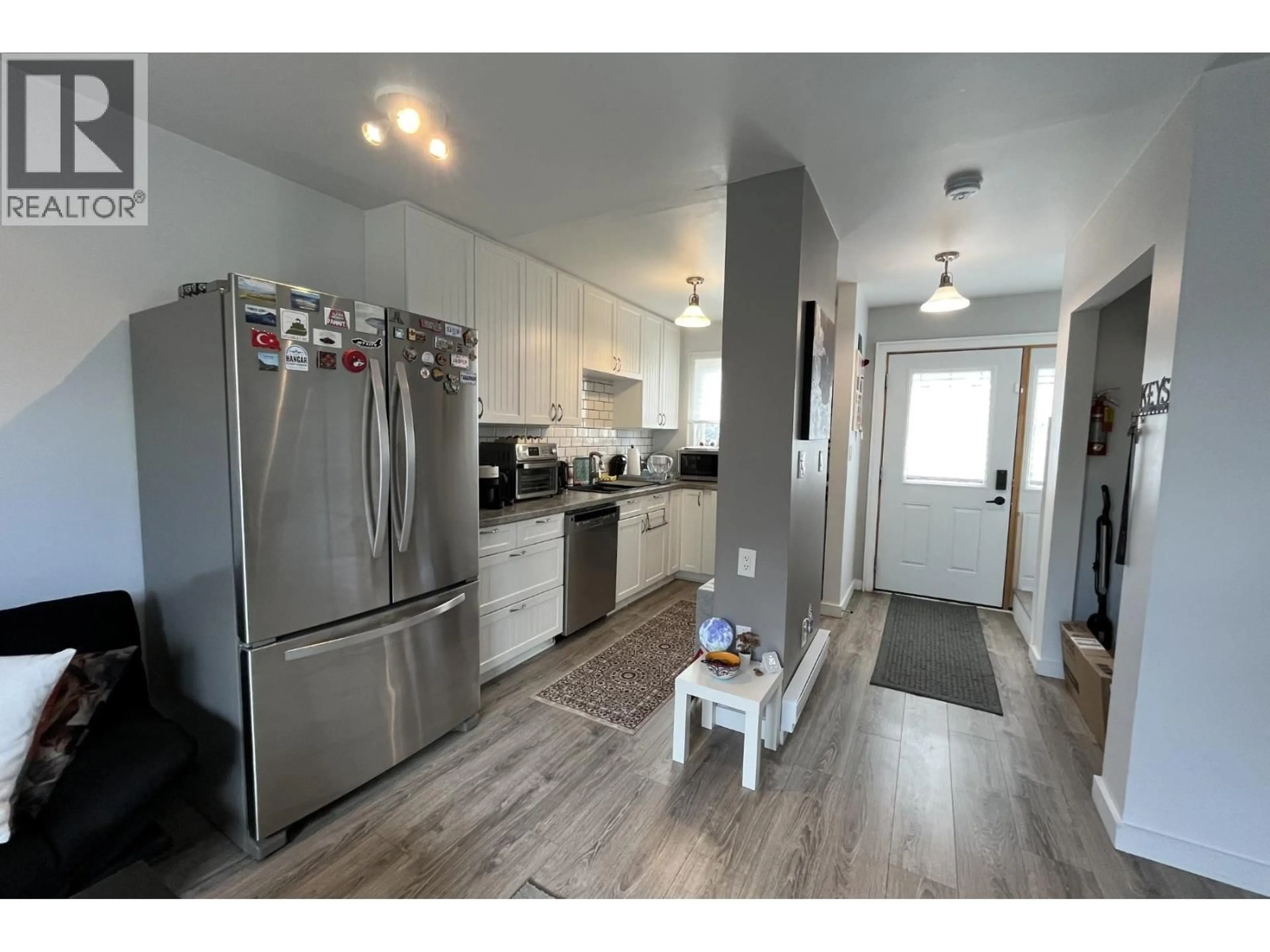Open concept kitchen, wood/laminate floor for 9827 97 STREET, Fort St. John British Columbia V1J3S4
