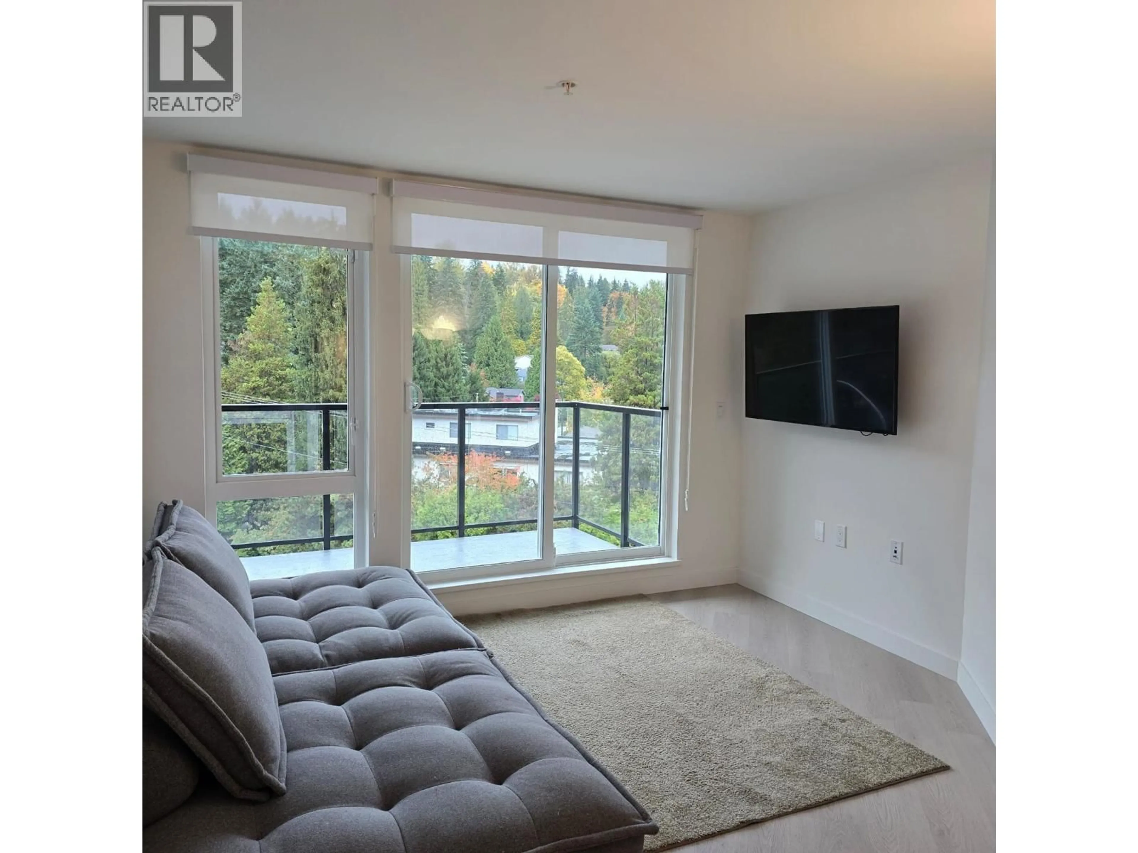 Living room with furniture, unknown for 406 - 1100 CLARKE ROAD, Port Moody British Columbia V3H0N3
