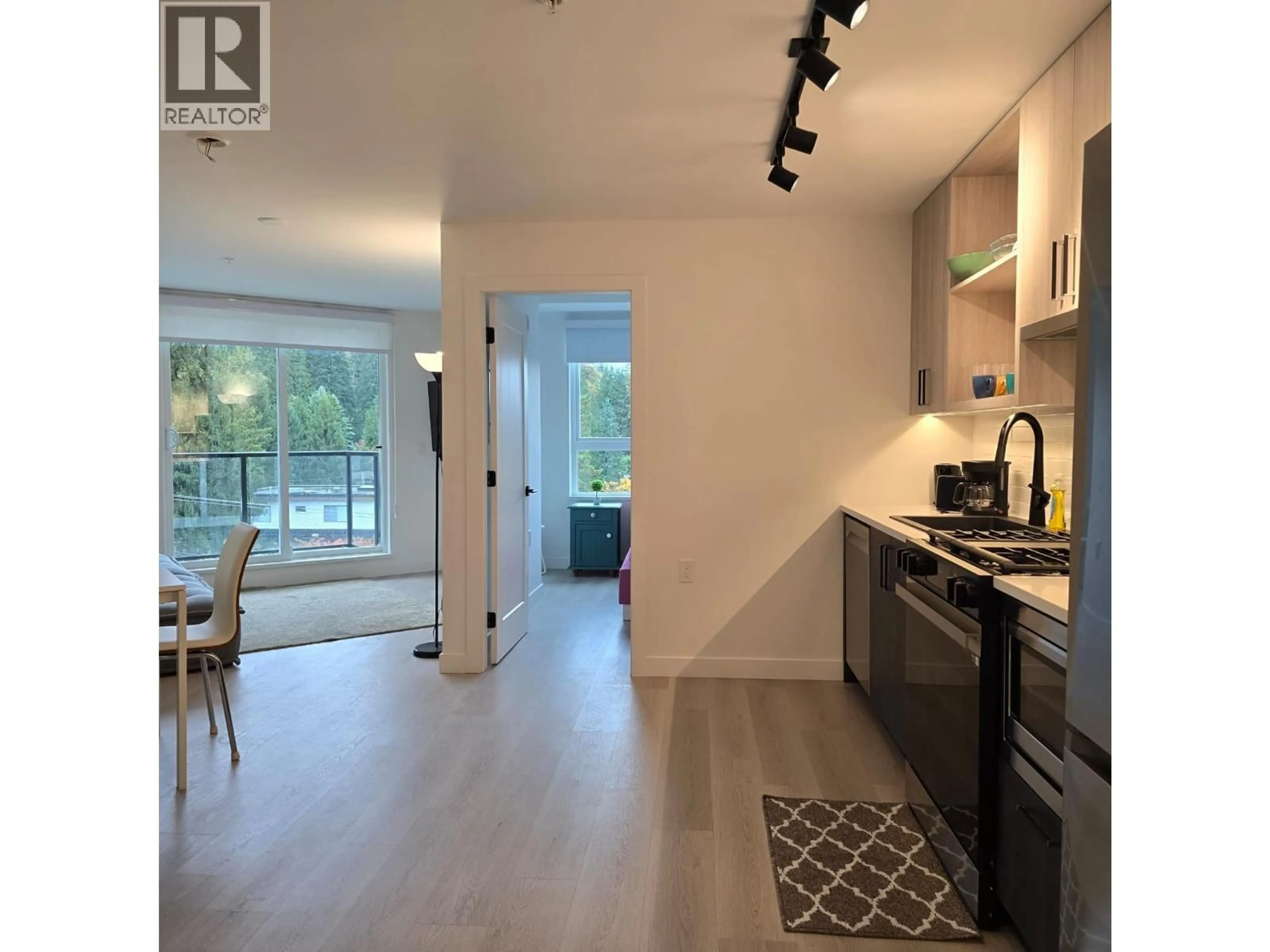Open concept kitchen, wood/laminate floor for 406 - 1100 CLARKE ROAD, Port Moody British Columbia V3H0N3