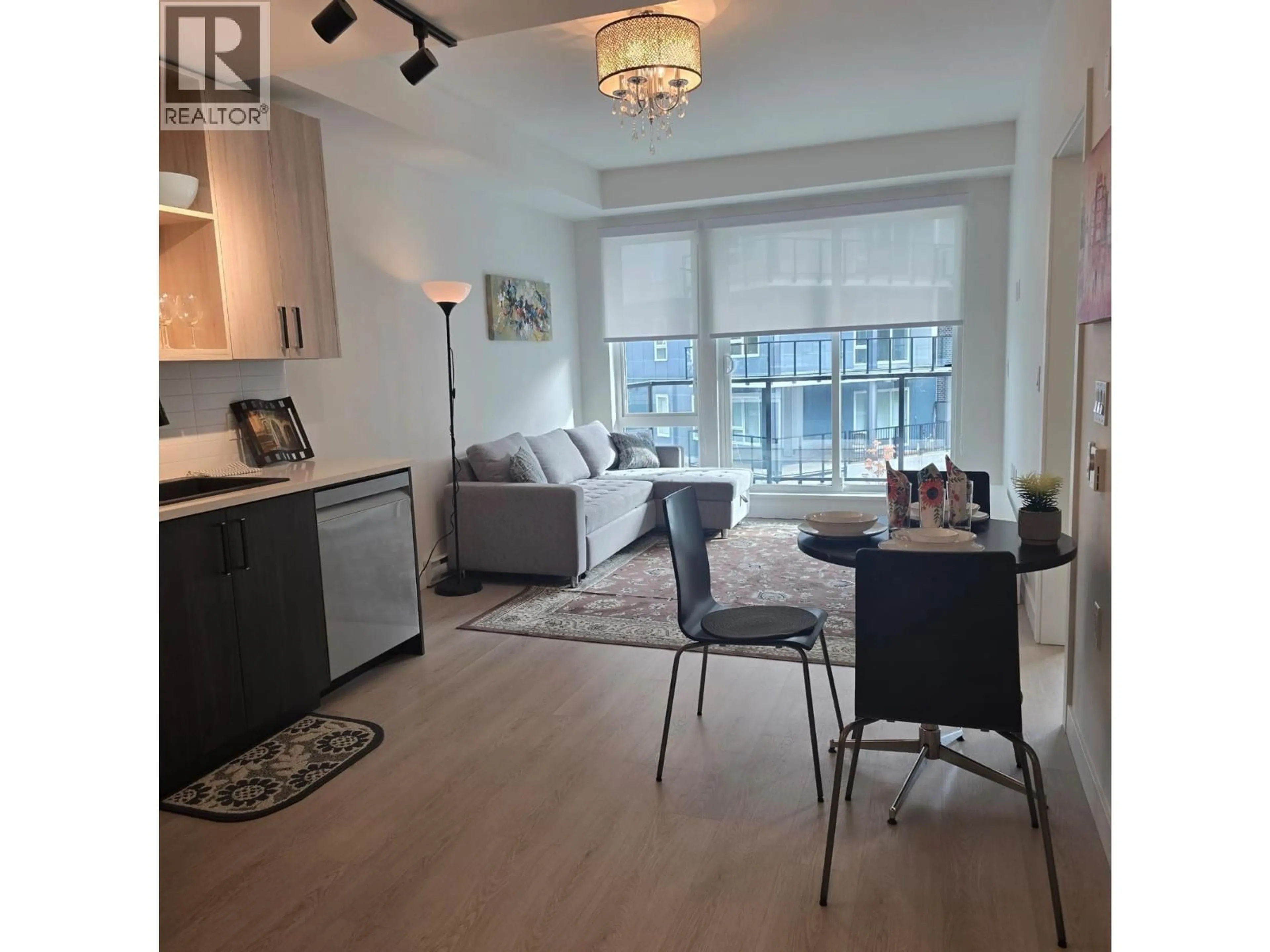 Living room with furniture, wood/laminate floor for 411 - 1100 CLARKE ROAD, Port Moody British Columbia V3H0N3