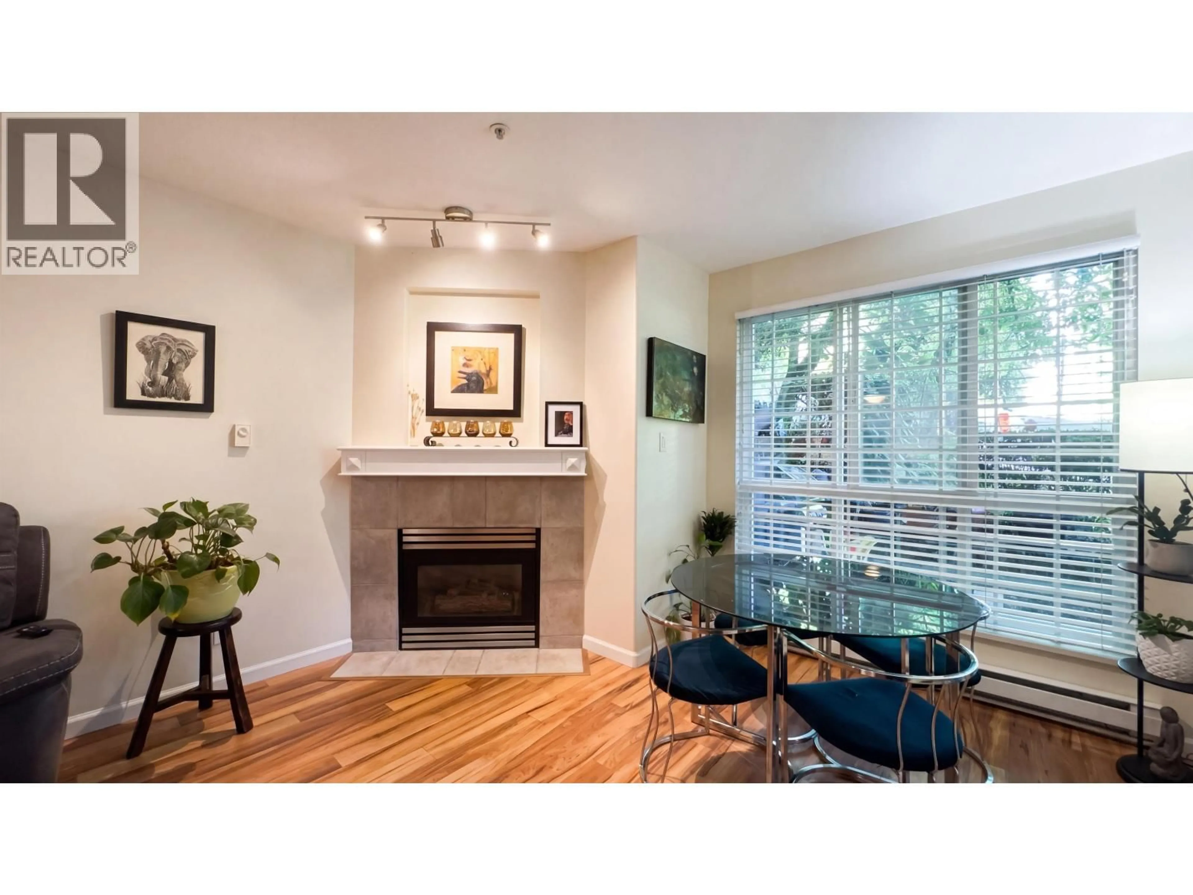 Living room with furniture, wood/laminate floor for 106 - 8495 JELLICOE STREET, Vancouver British Columbia V5S2J4
