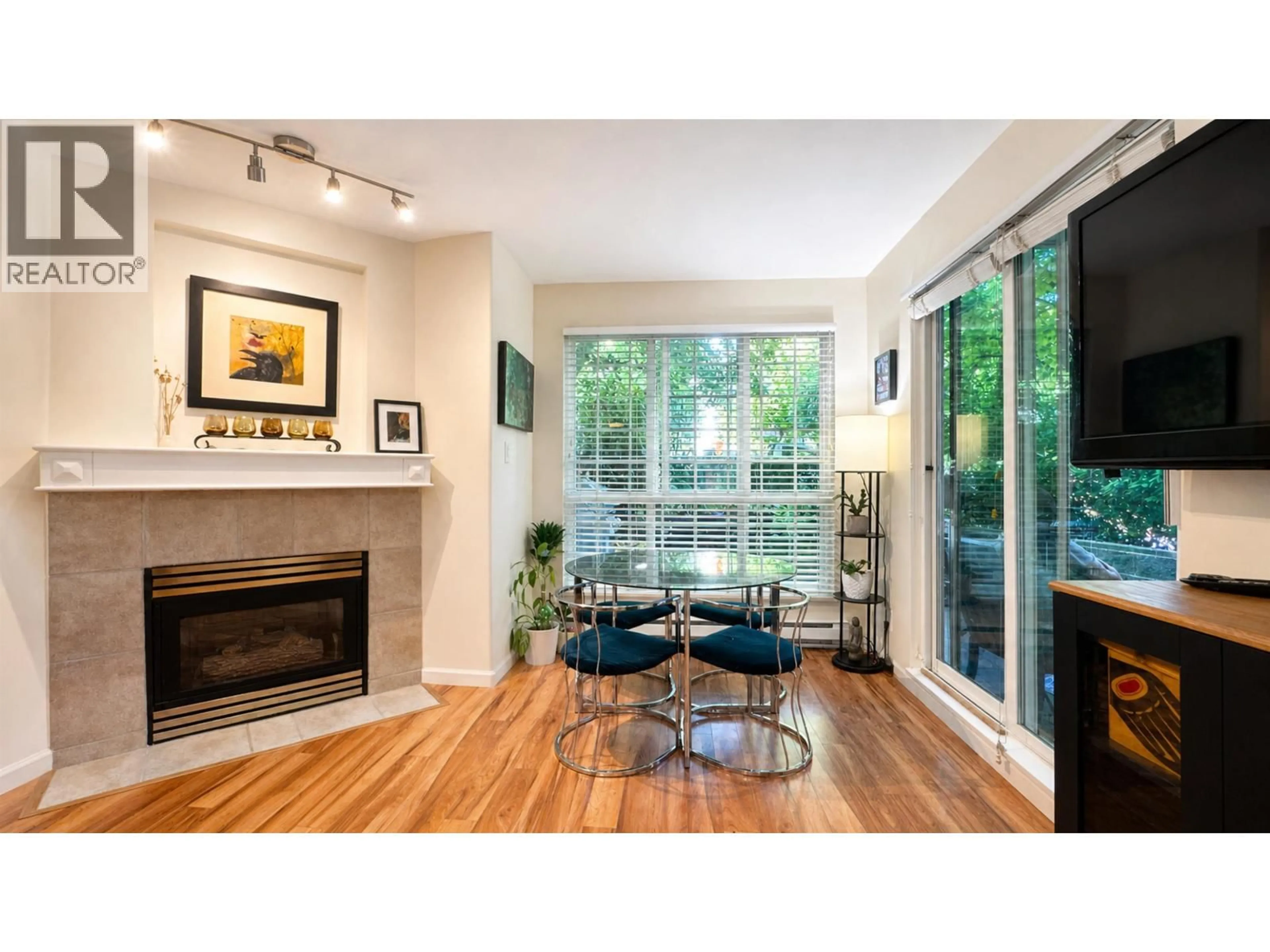 Living room with furniture, wood/laminate floor for 106 - 8495 JELLICOE STREET, Vancouver British Columbia V5S2J4