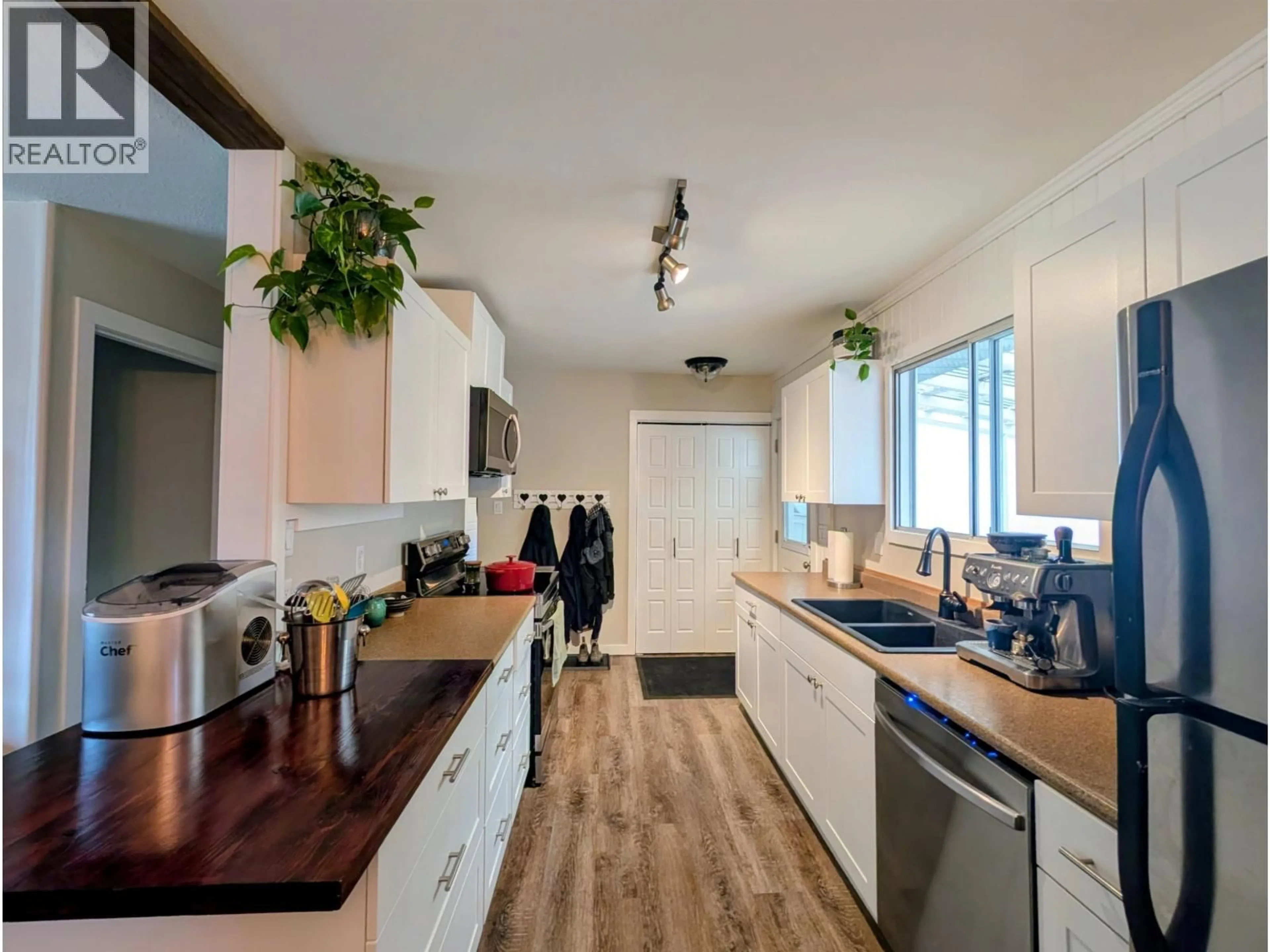 Open concept kitchen, wood/laminate floor for 1696 PRINCESS STREET, Smithers British Columbia V0J2N0