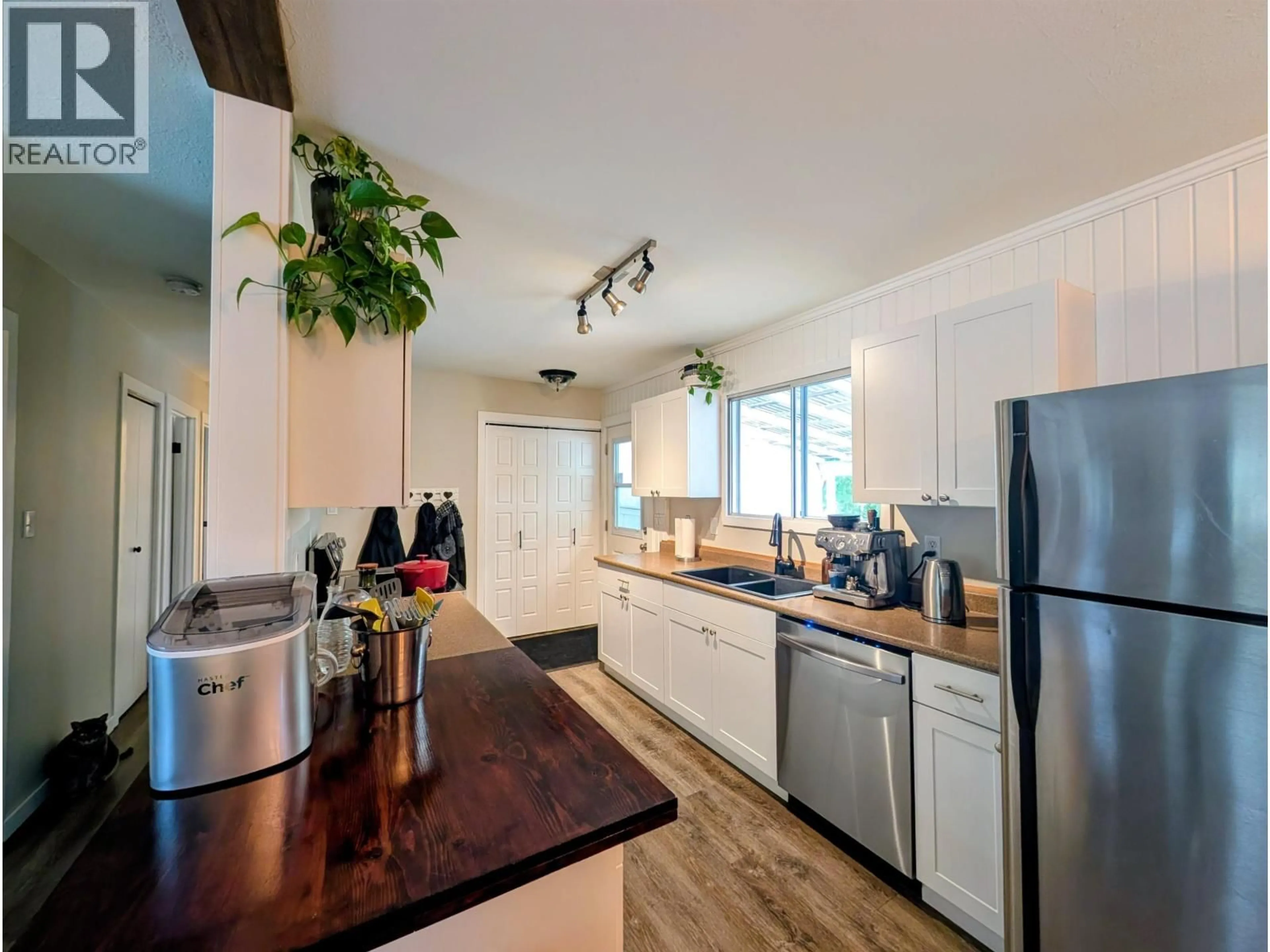 Open concept kitchen, wood/laminate floor for 1696 PRINCESS STREET, Smithers British Columbia V0J2N0
