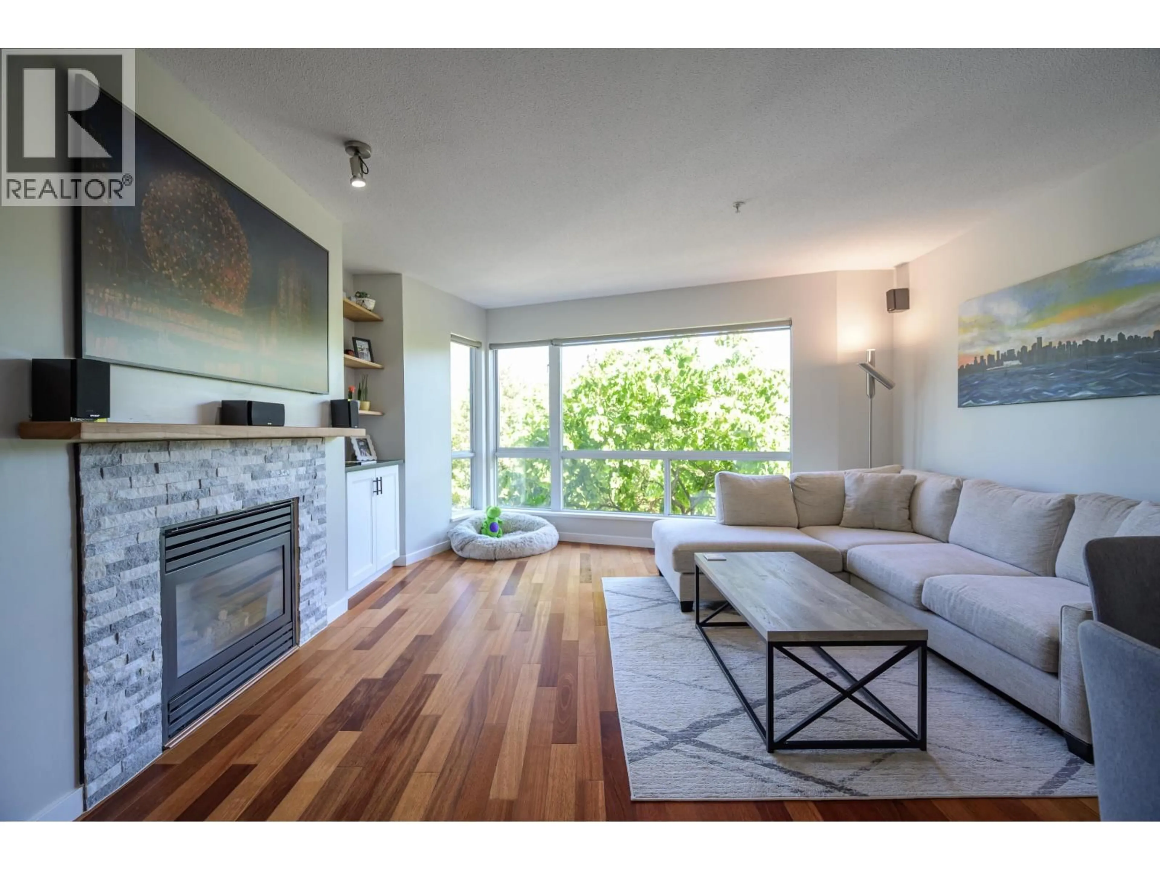 Living room with furniture, wood/laminate floor for 220 - 676 6TH AVENUE, Vancouver British Columbia V5Z1A3
