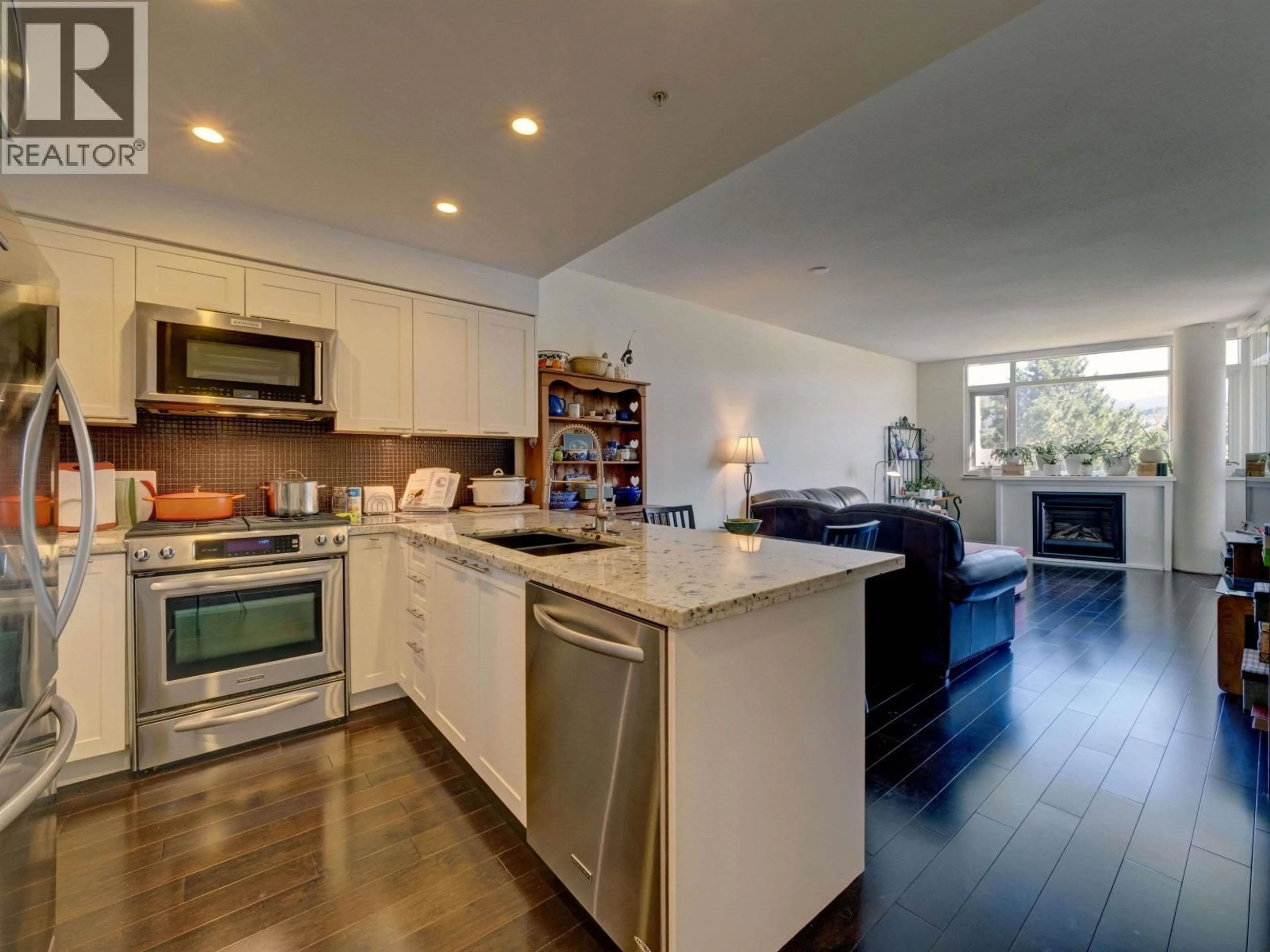 Open concept kitchen, wood/laminate floor for 307 - 5725 TEREDO STREET, Sechelt British Columbia V7Z0J2