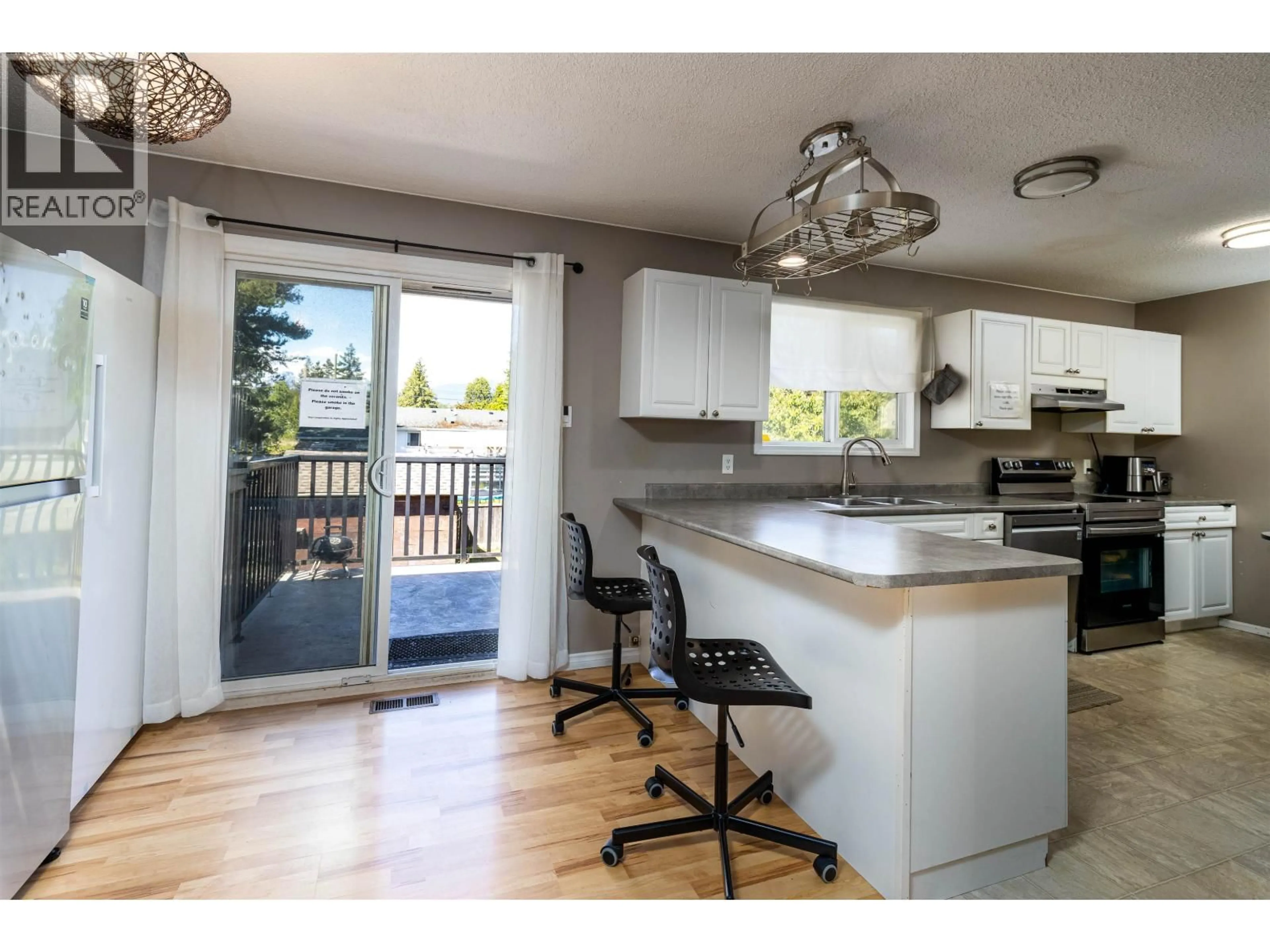 Open concept kitchen, wood/laminate floor for 4920 LAZELLE AVENUE, Terrace British Columbia V8G1T7