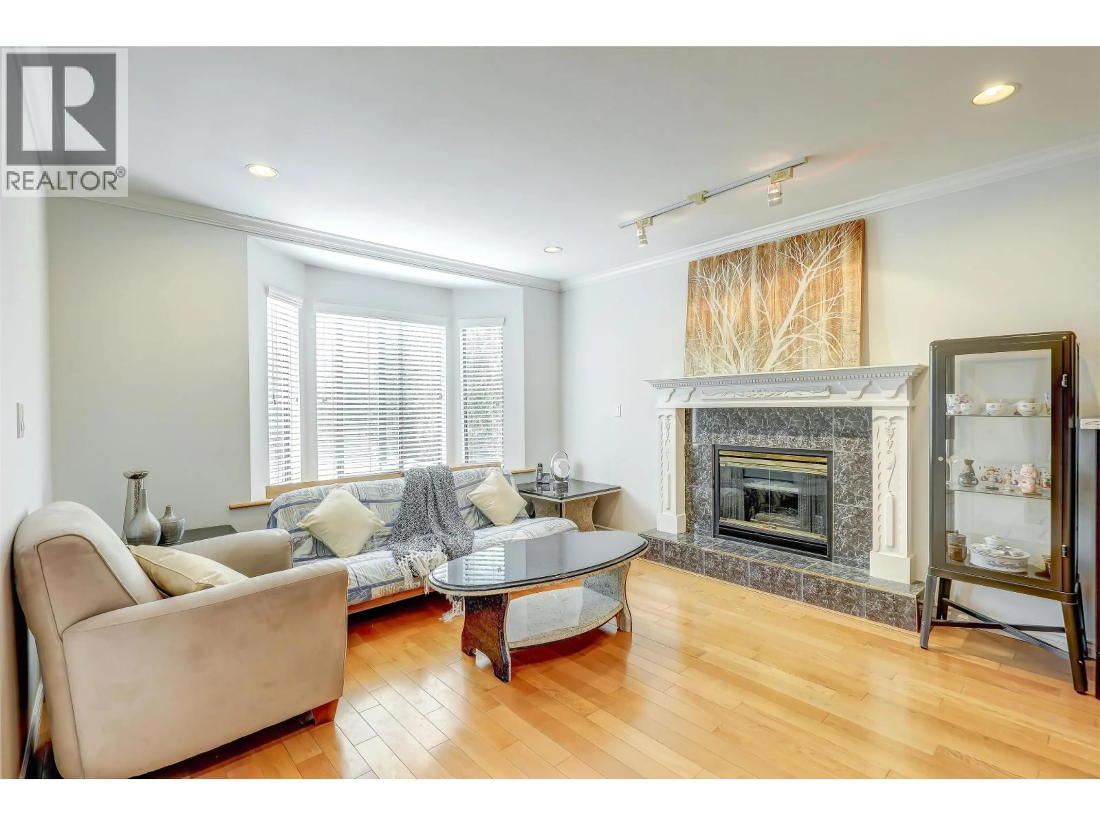 Living room with furniture, wood/laminate floor for 4723 VILLAGE DRIVE, Burnaby British Columbia V5G4V7