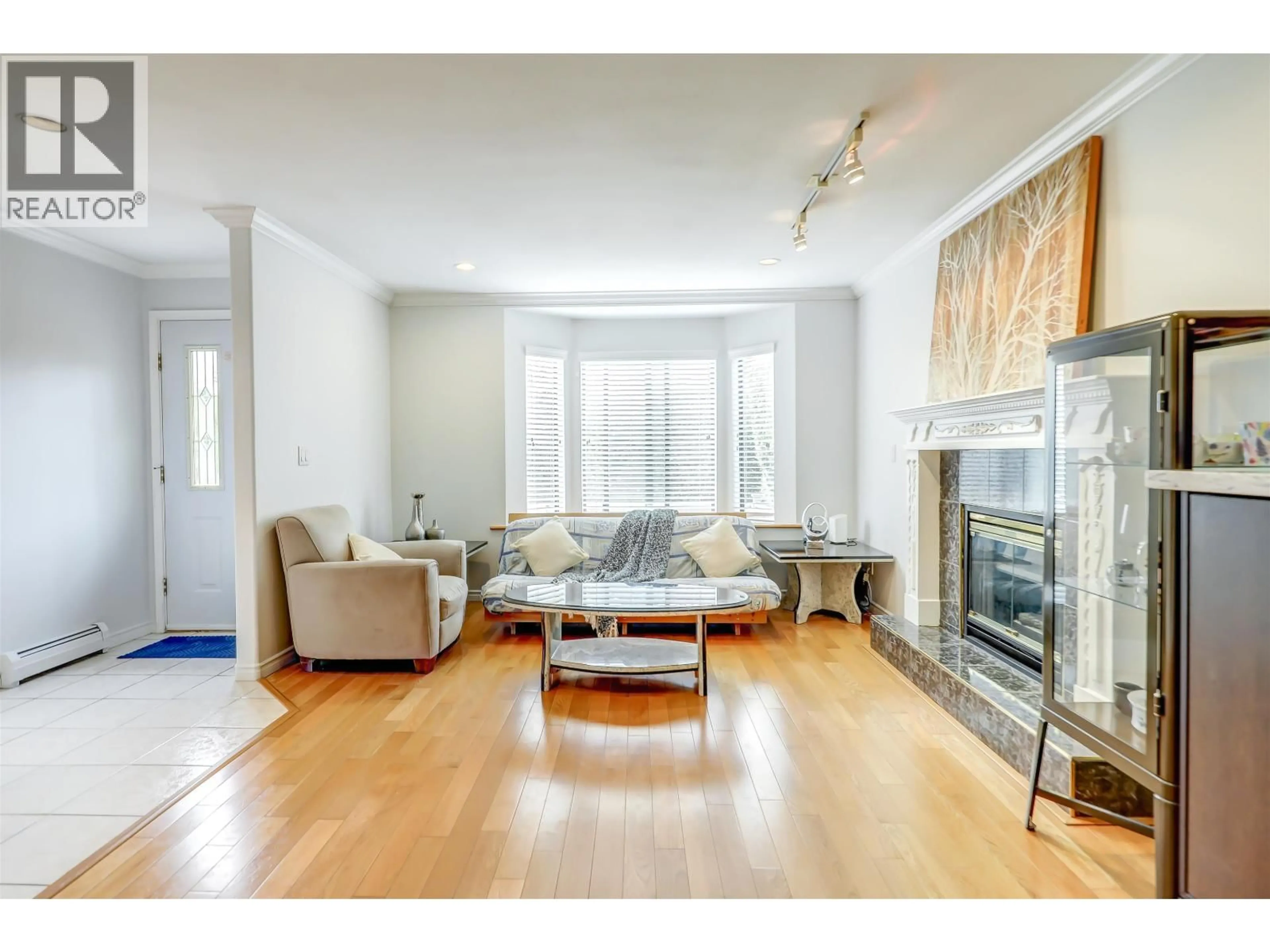 Living room with furniture, wood/laminate floor for 4723 VILLAGE DRIVE, Burnaby British Columbia V5G4V7