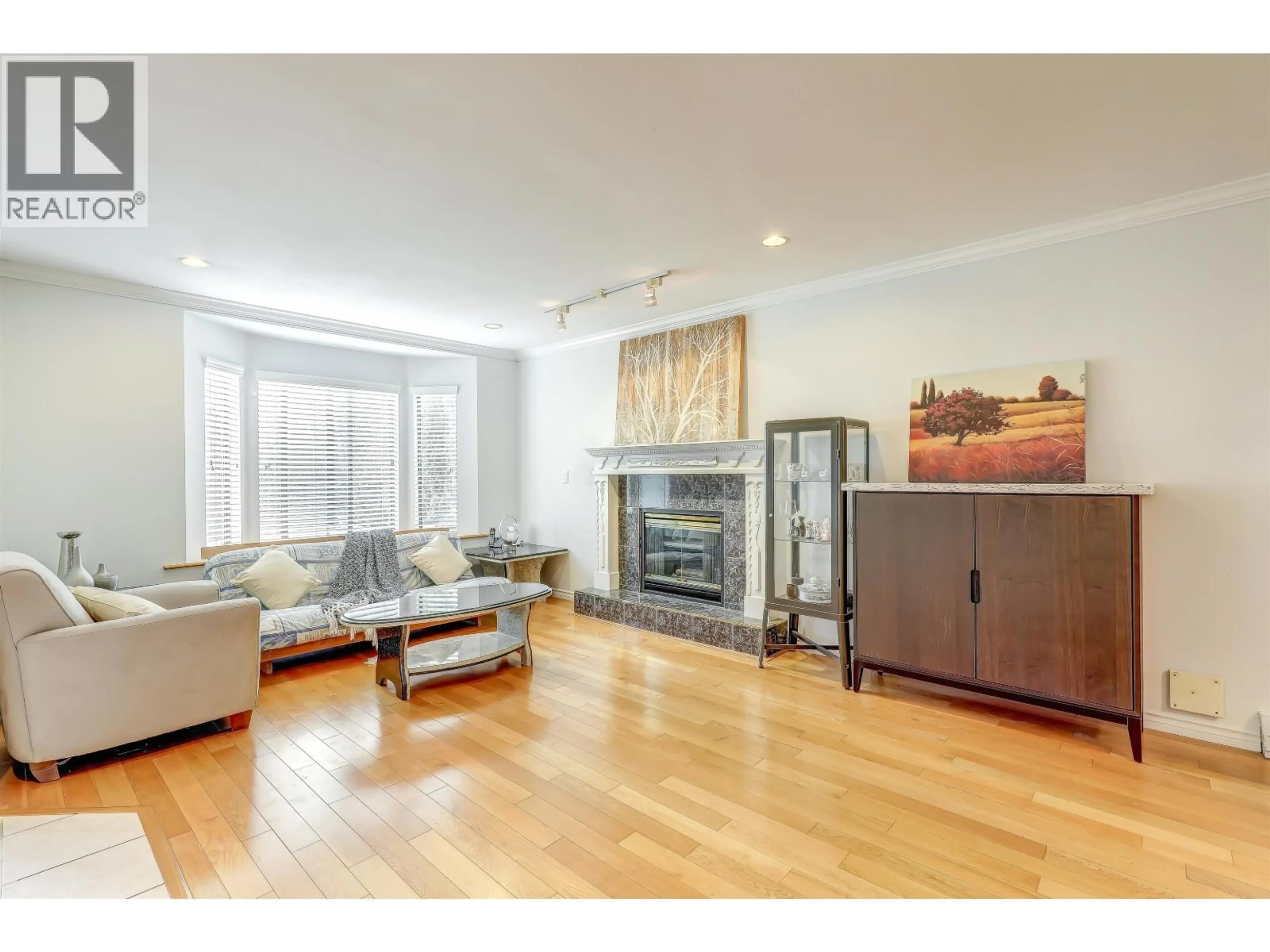 Living room with furniture, wood/laminate floor for 4723 VILLAGE DRIVE, Burnaby British Columbia V5G4V7