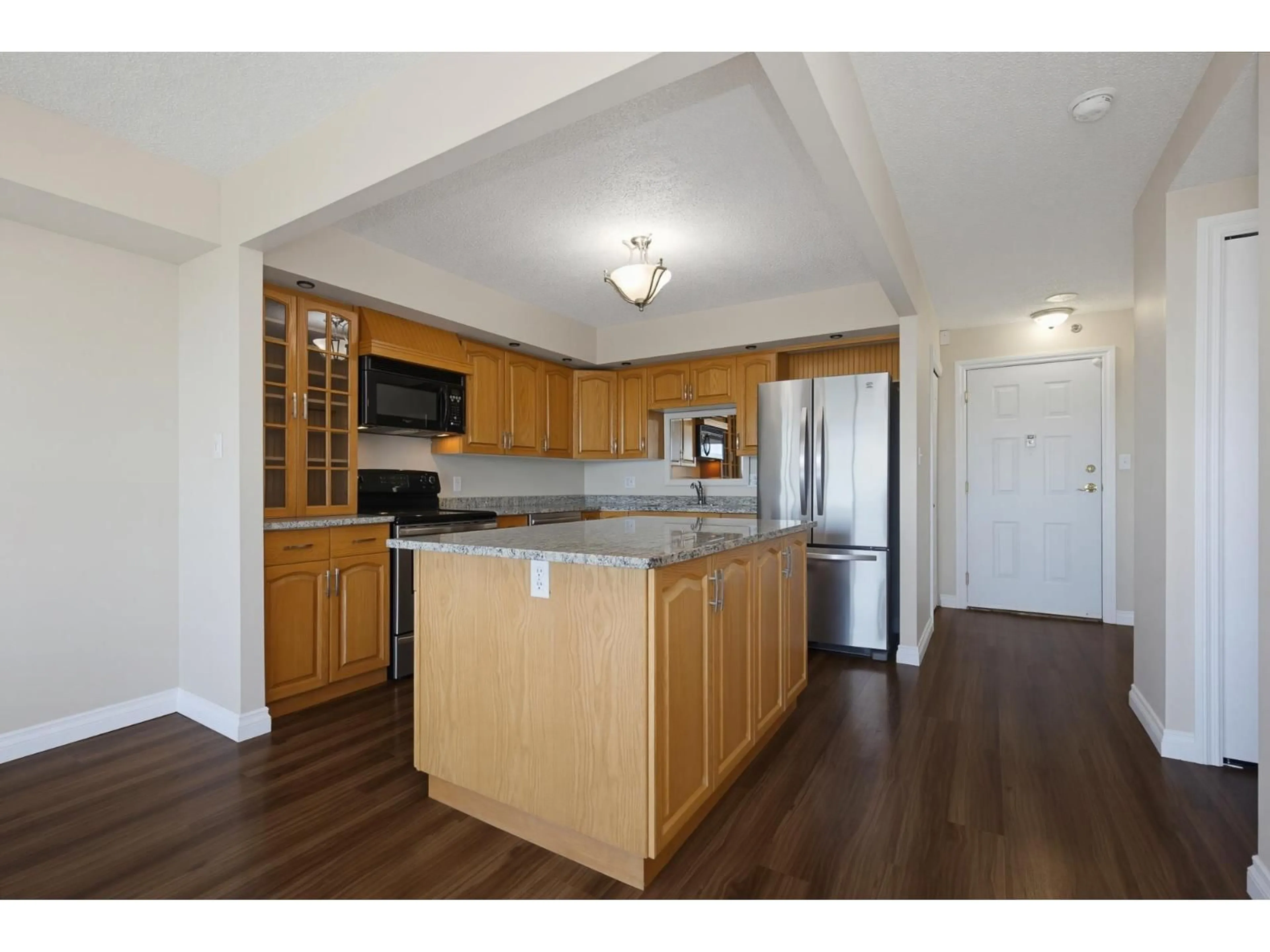 Open concept kitchen, wood/laminate floor for 1602 - 3150 GLADWIN ROAD, Abbotsford British Columbia V2T5S9