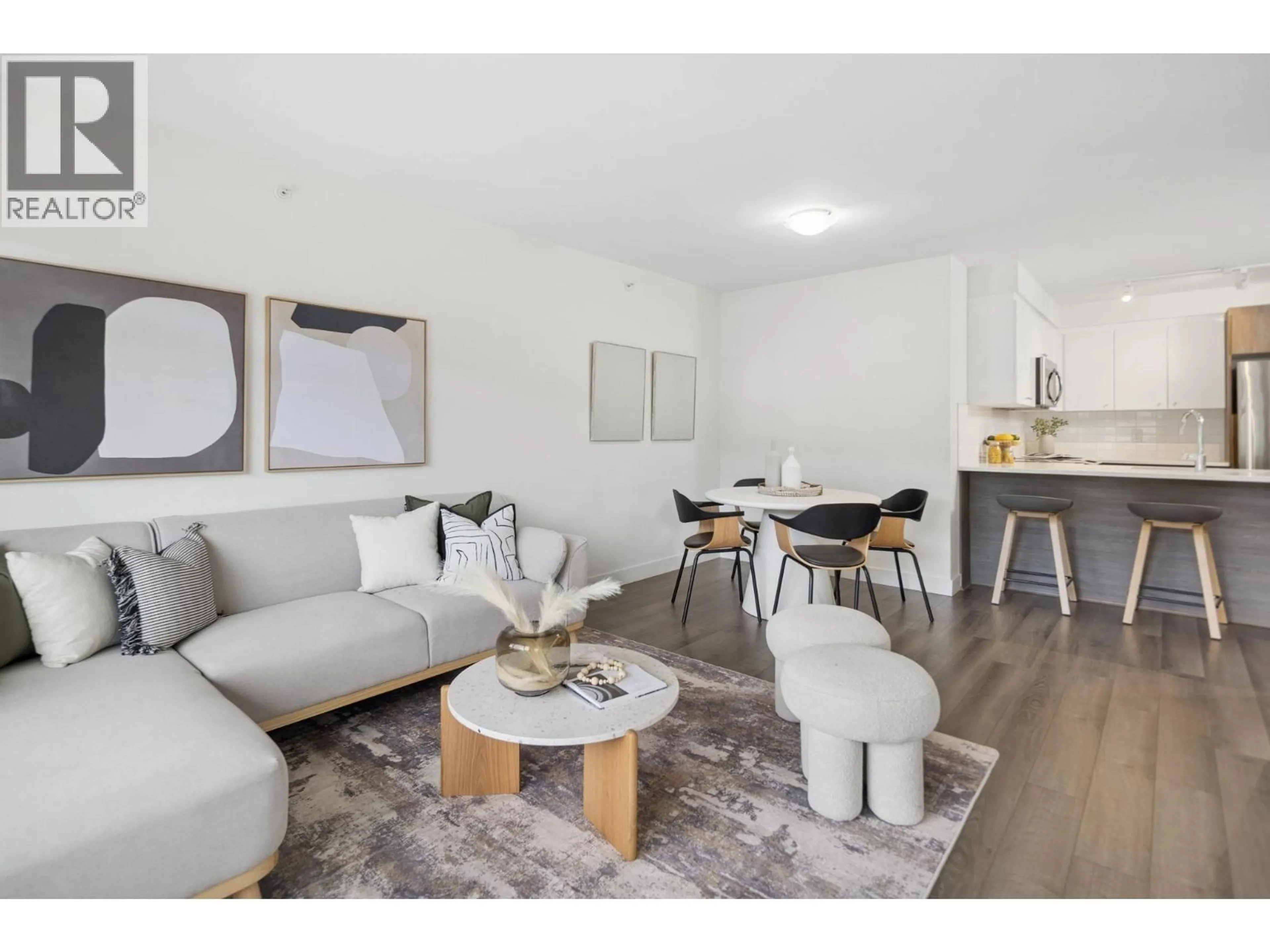 Living room with furniture, wood/laminate floor for 501 - 2525 CLARKE STREET, Port Moody British Columbia V3H1Z3