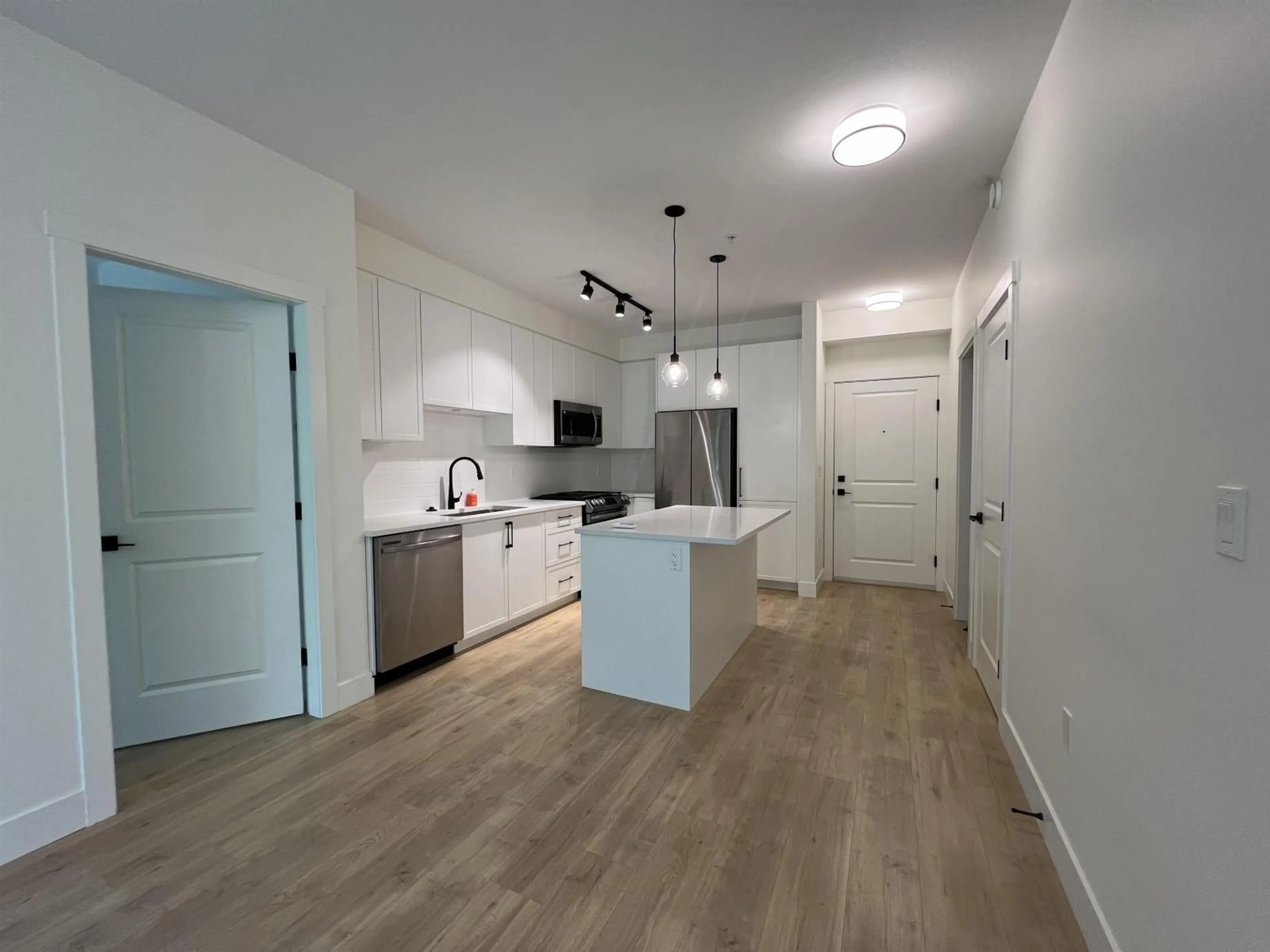 Open concept kitchen, wood/laminate floor for 208 - 7506 199A STREET, Langley British Columbia V2Y3K9