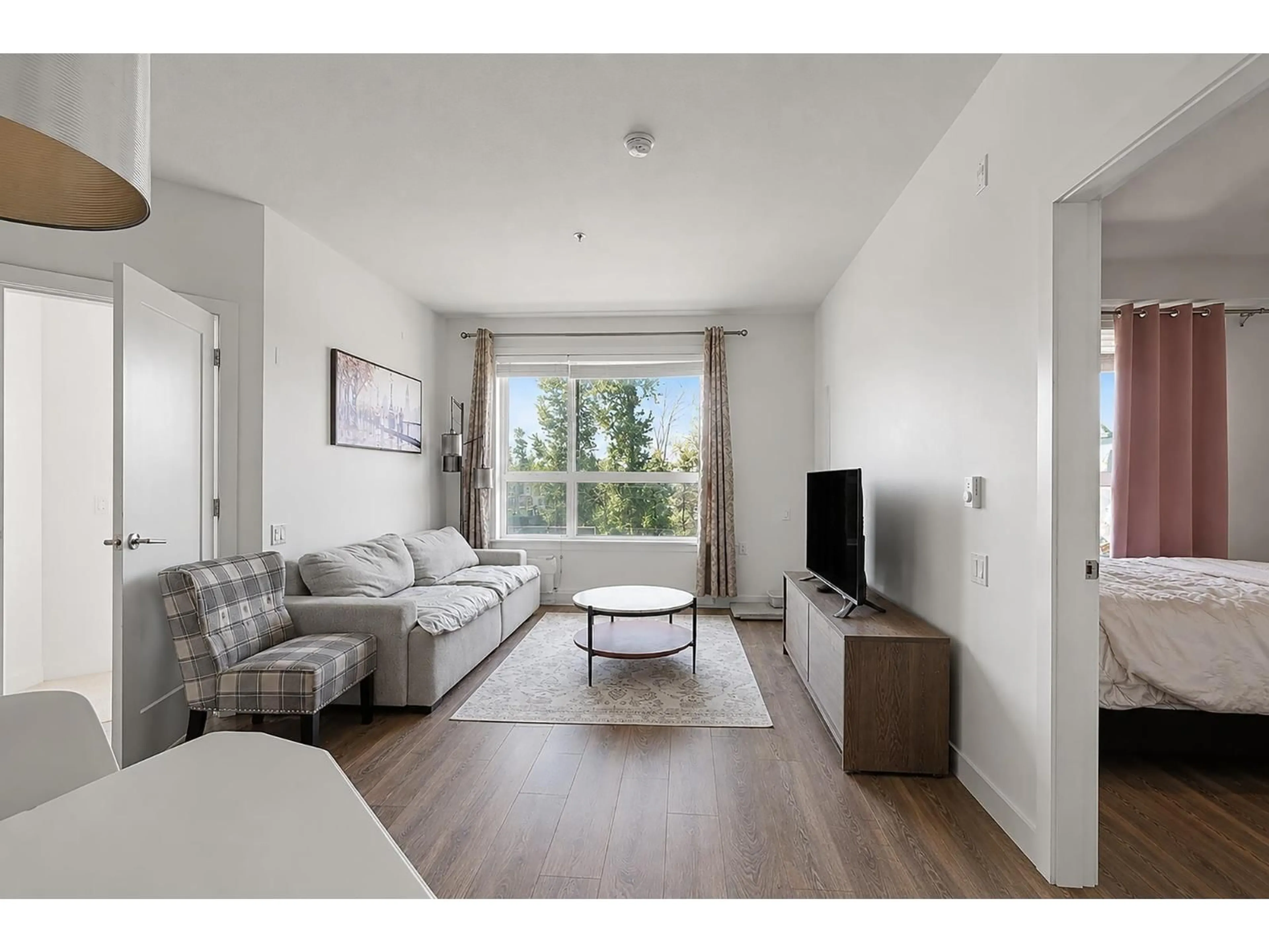 Living room with furniture, wood/laminate floor for 301 - 20829 77A AVENUE, Langley British Columbia V2Y0Y5
